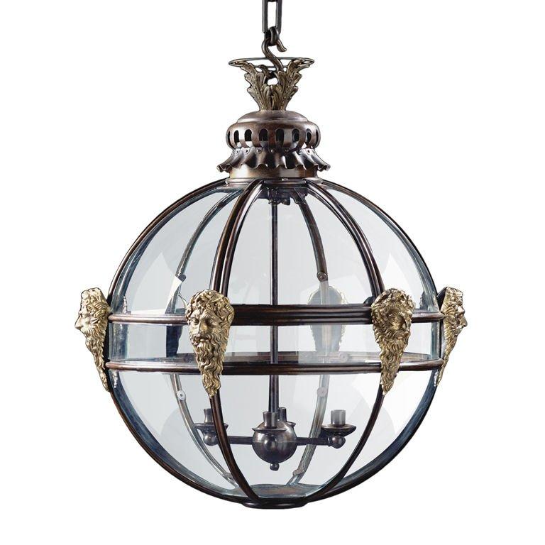 Made with hand-moulded copper and finished in bronze, this large glazed, spherical lantern is enriched with cast brass masks. The masks, with long beards, represent Neptune, the God of the Sea. The leaf cast finial rests on a pierced cupola designed