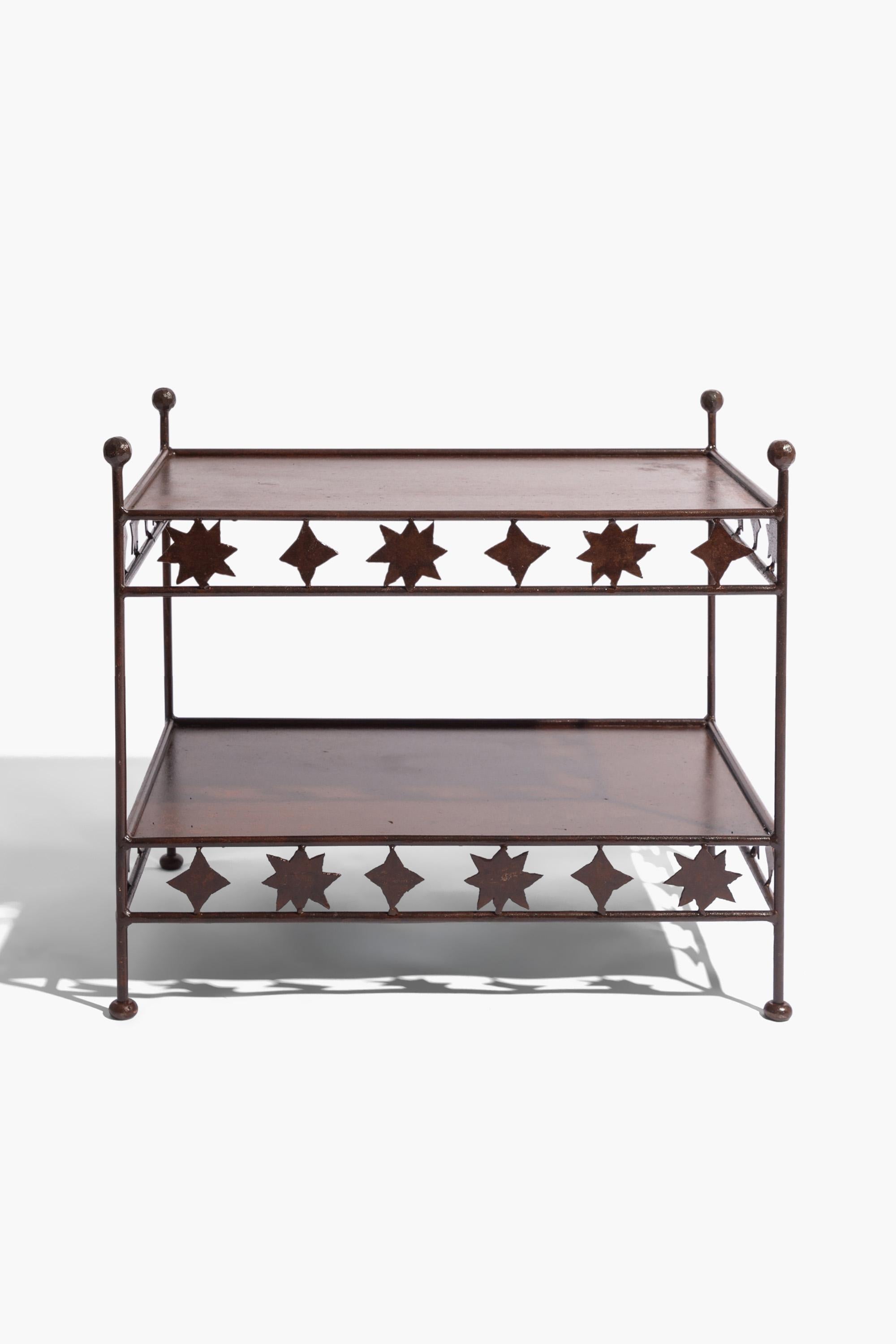 The 'Matisse' wrought iron side table.

A hand made and patinated wrought iron etagere with whimsical Matisse style cut-out decoration. Made to order based on a 1960s original. Available in custom sizes, the design works well as a console, bedside
