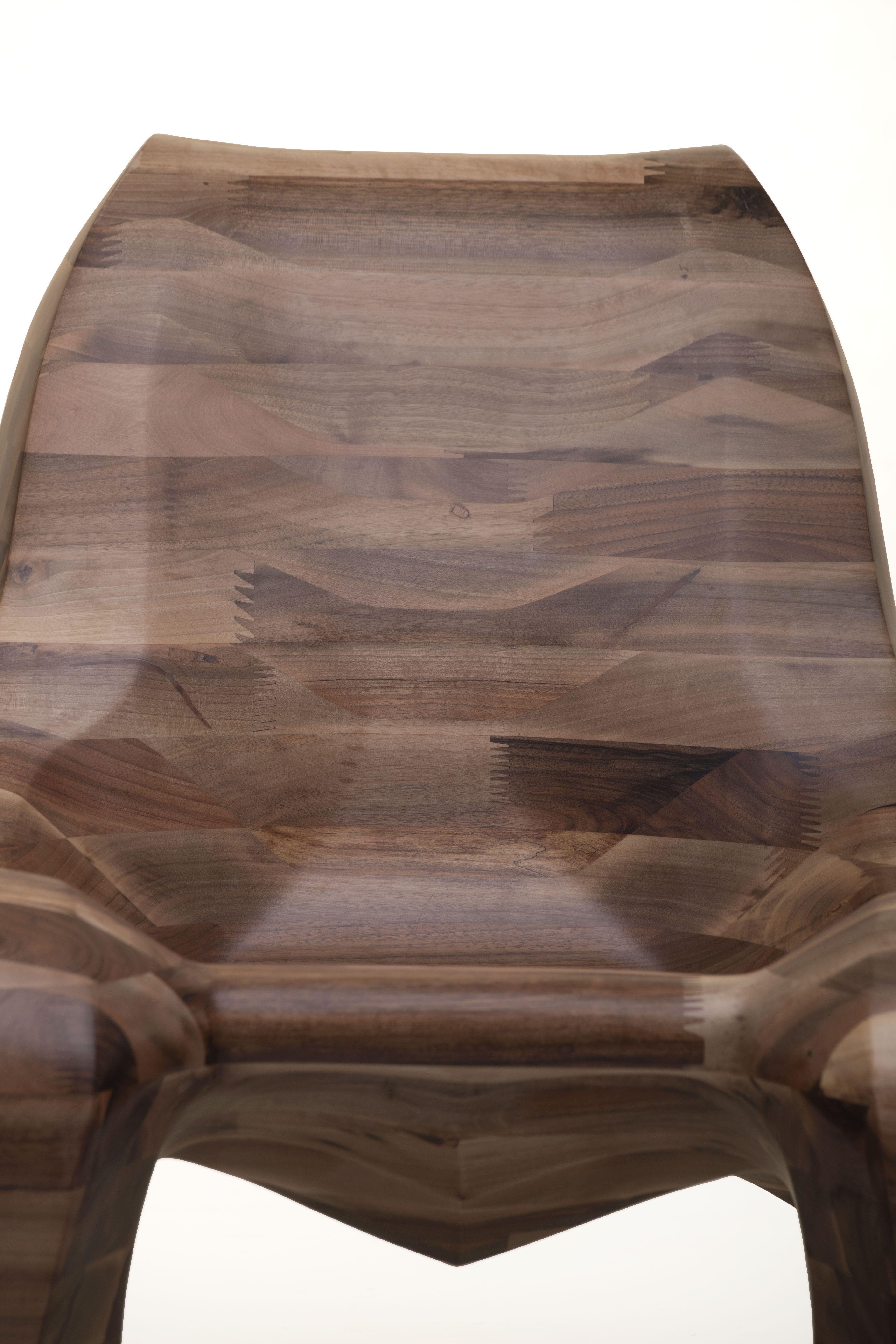 The Club 107 walnut by Max Jungblut is a timeless natural beauty, unique by its genuine material.
Solid Walnut beams with magnificent wood texture, softly follow the rounded form of this chair.
This ultimate seating is made in a 4-axel CNC