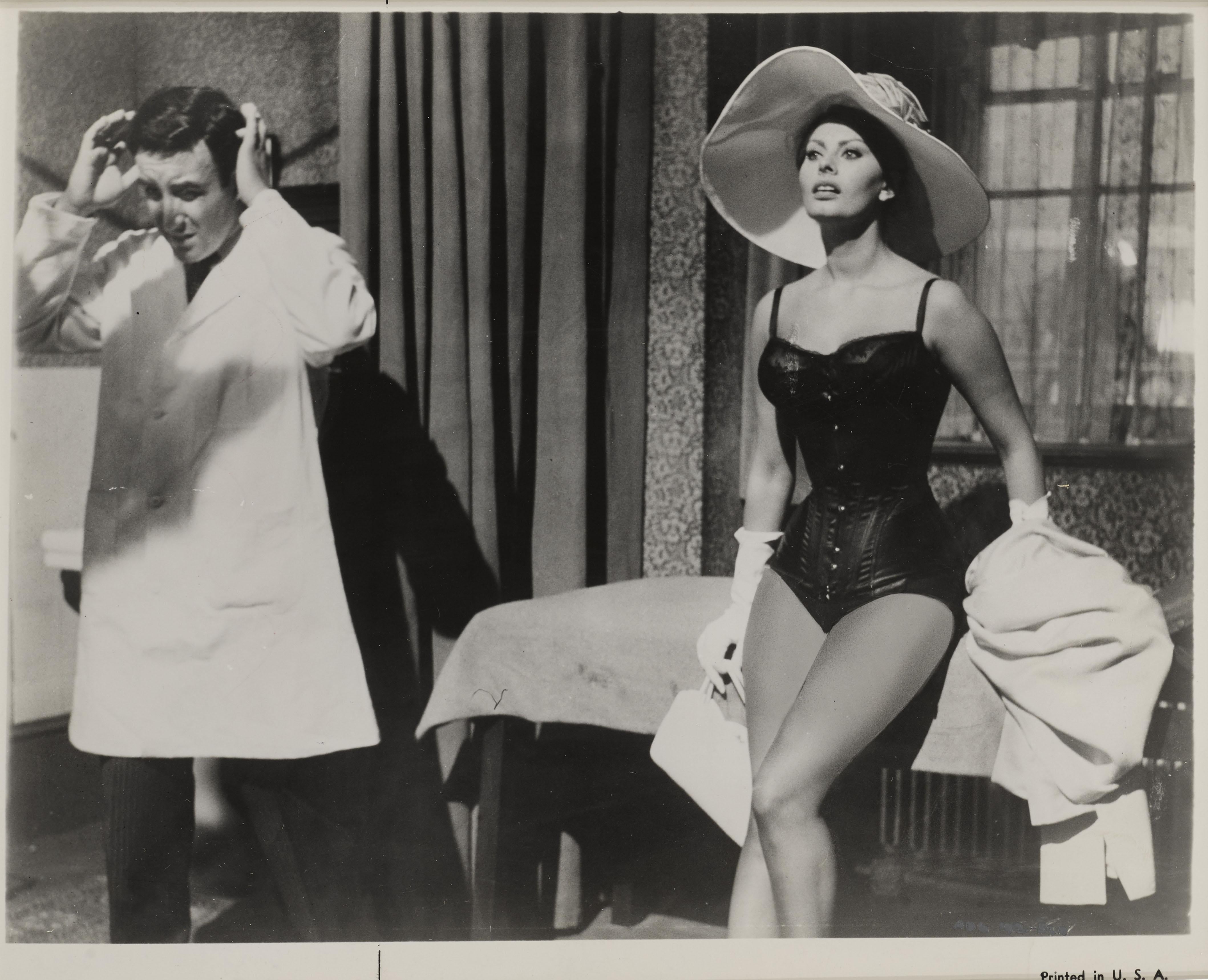 Original black and white production still from The Millionairess 1960.
The film was directed by Anthony Asquith. And starred Sophia Loren, Peter Sellers and Alastair Sim.
This piece is conservation framed in an Obeche wood frame with card mounts
