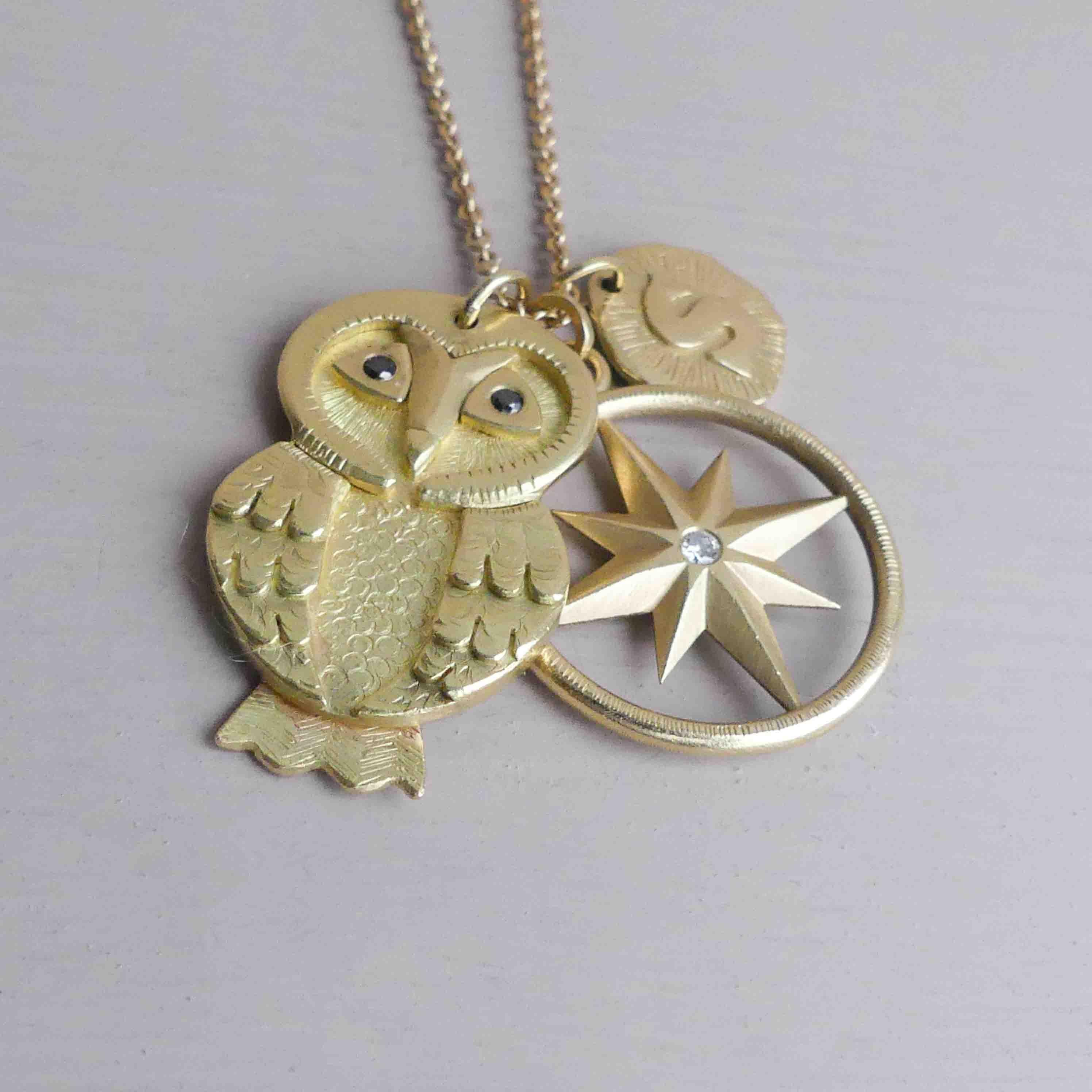 The Minerva Owl Amulet - an ethically handcrafted gold owl pendant handmade using 18ct Fairtrade gold and accented with two black diamonds eyes.

Owls are the shamans of the bird world and have appeared in myths and folklore worldwide for centuries.