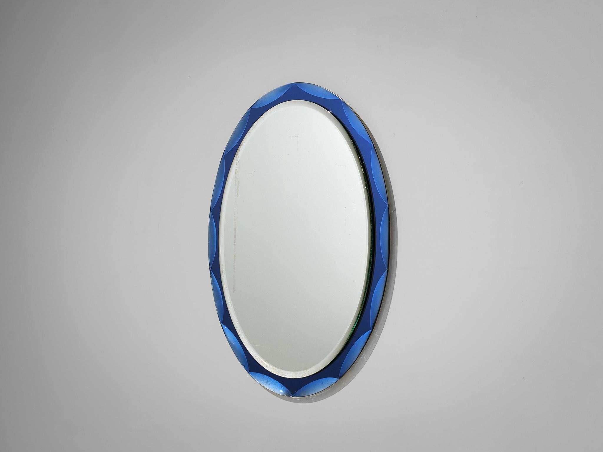 Italian shield mirror with cobalt blue detailed frame, Italy, 1950s

The mirror is surrounded by beveled blue glass frame. The glass scalloped rim has been nicely executed in cobalt blue, inspired by Arte Shield mirrors. A stunning mirror with