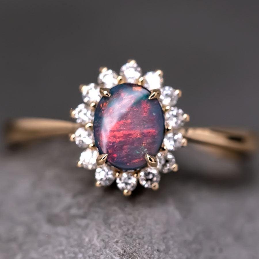 The Modern Classic - Australian Black Opal Diamond Halo Engagement Ring 18K Yellow Gold.



Design Name: The Modern Classic

Design Concept: A luxurious blend of timeless and modern style. This engagement ring features a top-quality Australian black