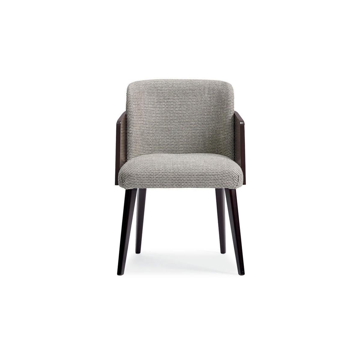 The Modern dining chair with Neo-classical design elements gives this distinctive chair a modern feeling while evoking a 1970s aesthetic. The angular legs are finished in a timeless Modern Walnut while a shapely barrel back is wrapped in Ebony