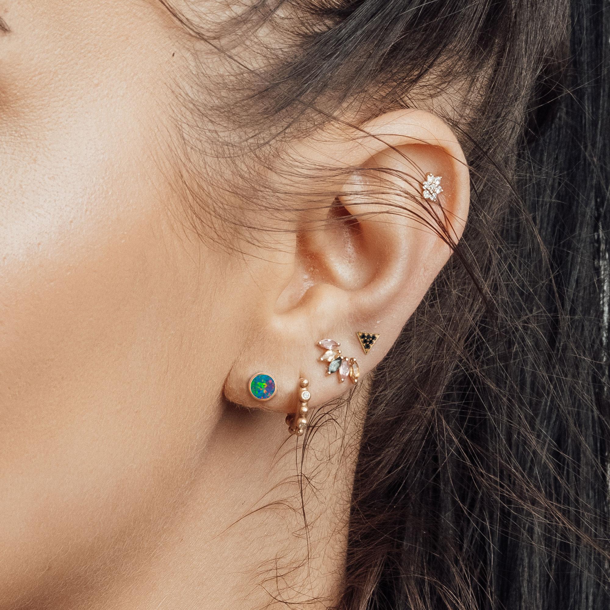Calling all globe trotters! This brightly polished 18k gold solitaire design of gold stud earrings. This gorgous beauty features a vibrant opal gemstone bezel set, giving it an otherworldly-beauty reminiscent of an earth globe. Add a contemporary,