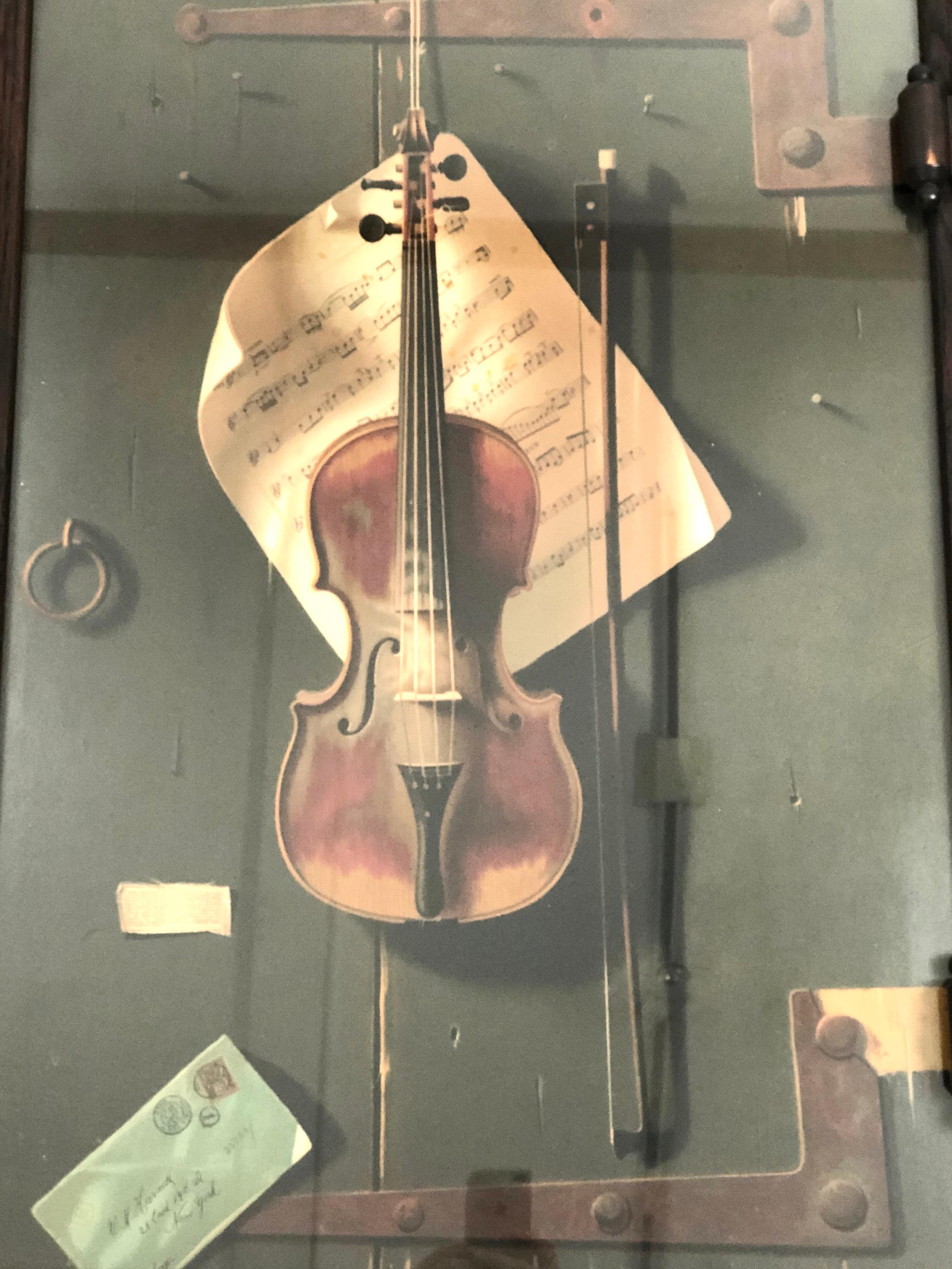 An original lithograph print of the famous William Michael Harnett (1848-1992) painting entitled The Old Violin, published by F. Tuchfarber, Cincinnati, Ohio, circa 1887, in its original carved oak trompe l'oeil frame with carved hinge and latch