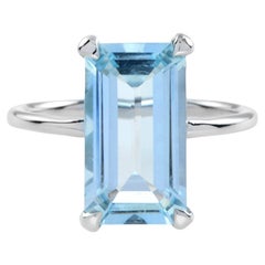 One Emerald Cut Sky Blue Topaz Solitaire Engagement Ring in 9K White Gold