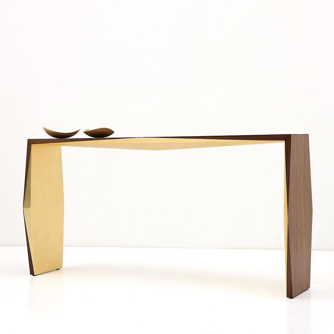 This console is an extension of the famous Origami Collection by Nada Debs. The beauty of this collection lies within the folds along the piece's edges that mimic the Japanese paper folding technique. The console is offered in American walnut