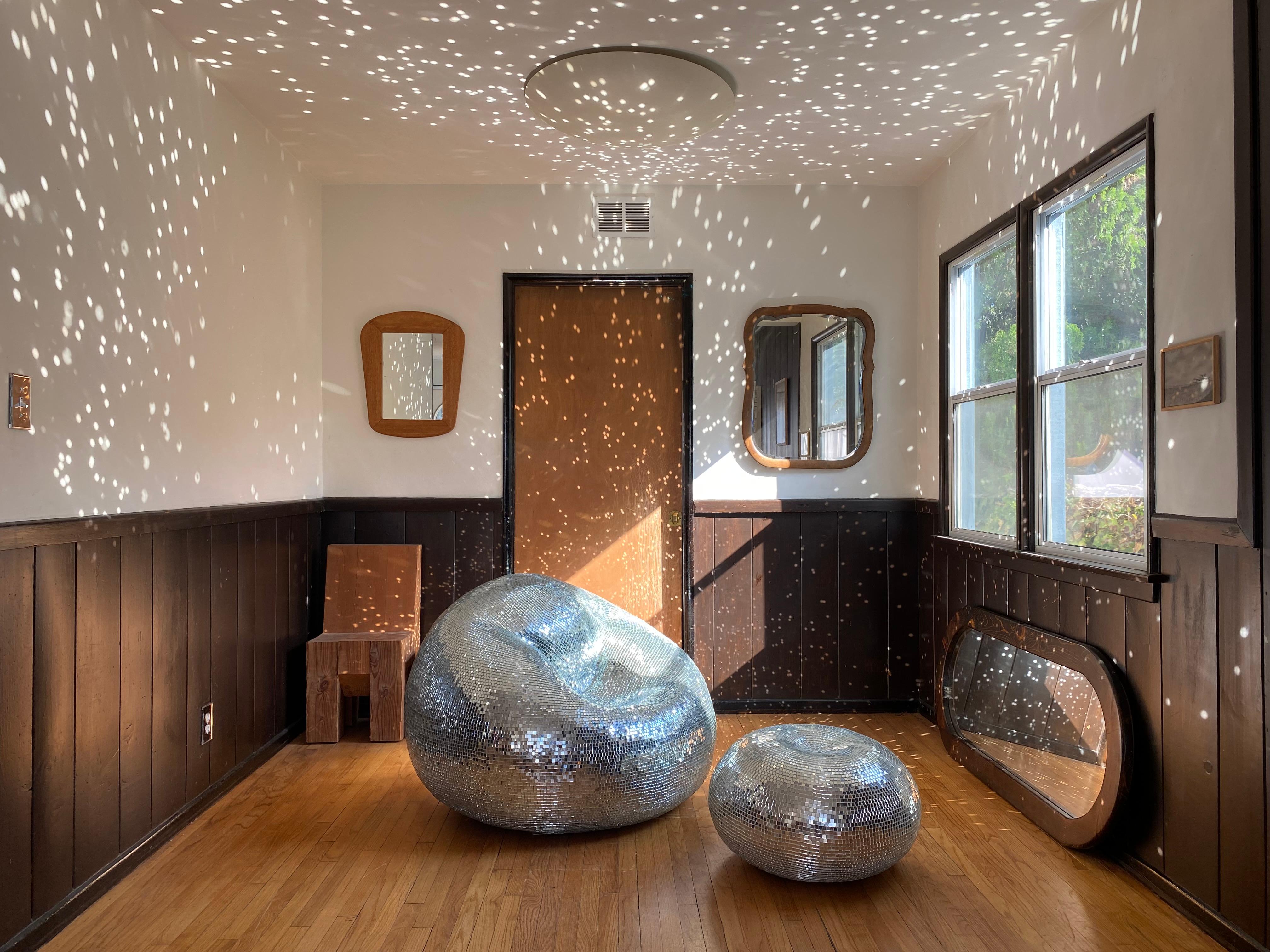 The iconic Disco Chair (c. 2020) by Rachel Shillander, though often wrongly attributed to Kelly Wearstler, in a 15mm glass mirror tile version. The chair is a hollow, thin-concrete monocoque shell, formed over an inflatable mold and covered in