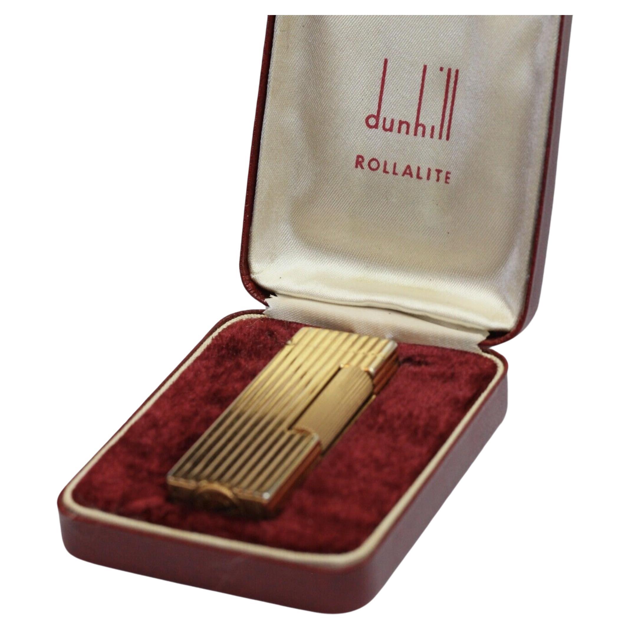 This Rare Original James Bond Vintage 1950s Dunhill ROLLALITE Gold Plated Lighter 
In Mint Working condition 
In the original British Red Sky Case with the Luxury red Velvet interior
The lighter is gold plated and in excellent condition 
There is an