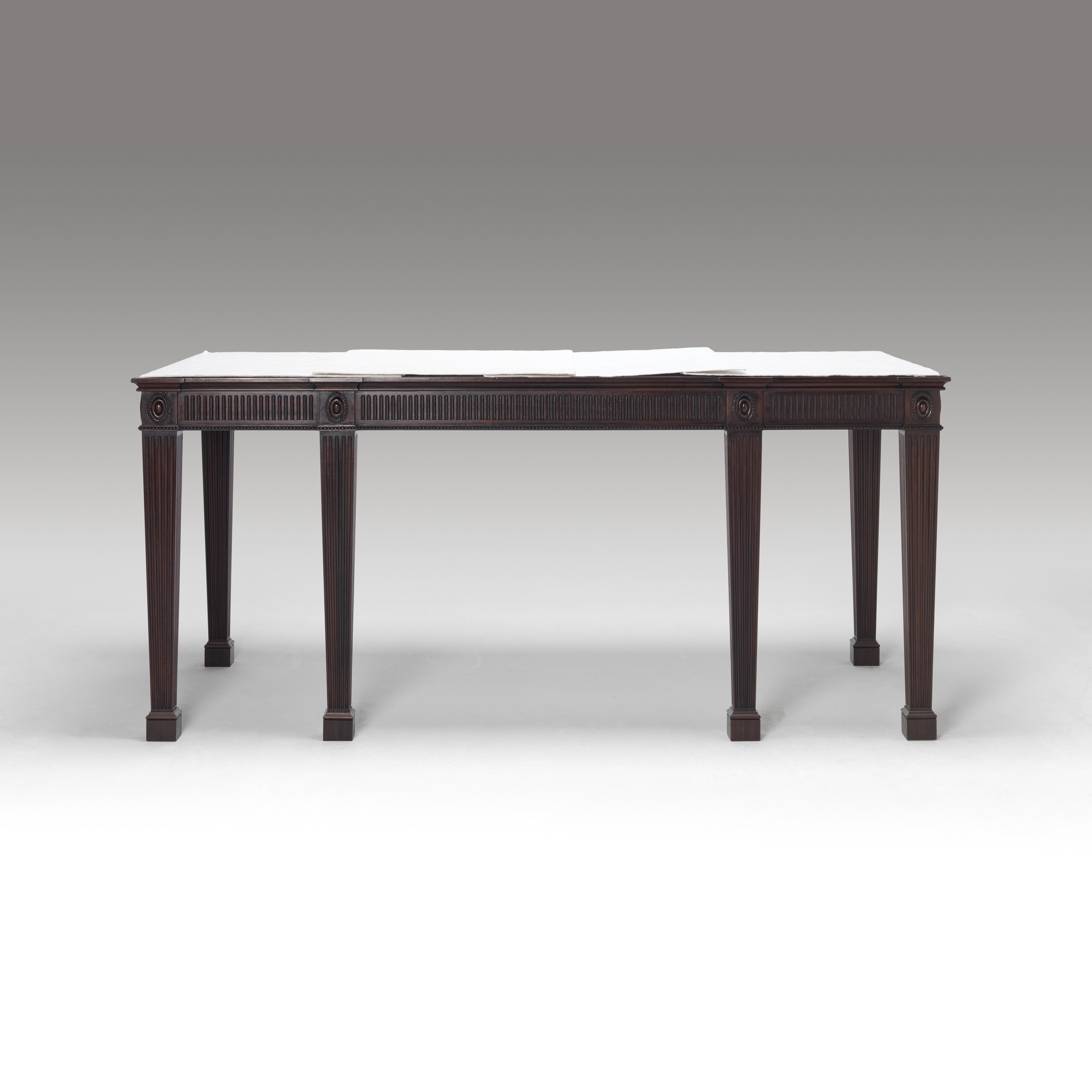A finely carved specialist polished mahogany console table with rectangular marble top above a finely fluted frieze on square and tapering fluted legs headed by paterae on block feet. Please note we are currently working to a 30-36 week lead time. 