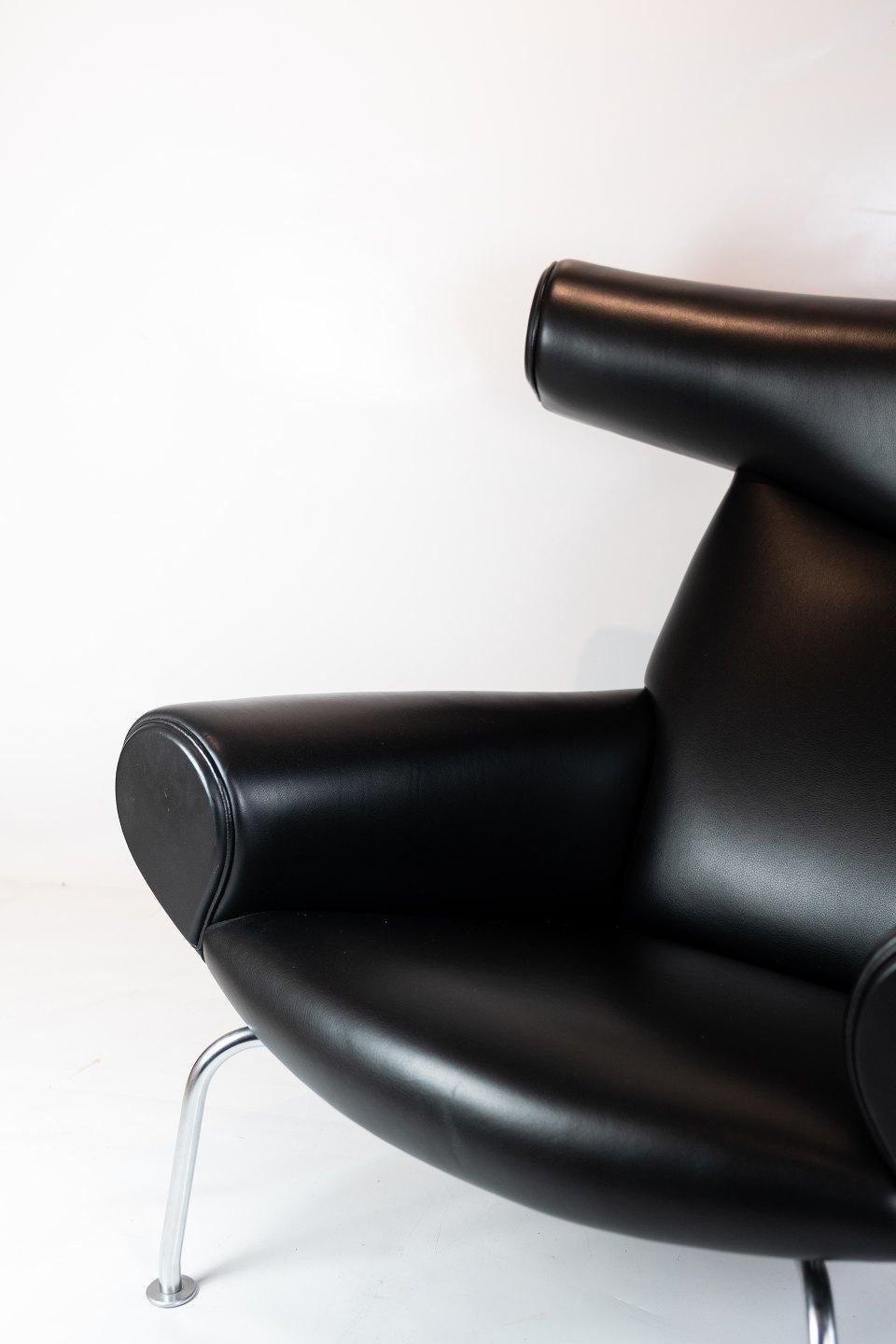 The Ox chair, model EJ 100 upholstered in black leather, designed by Hans J. Wegner in the 1960s and manufactured at Erik Jørgensen furniture factory. The chair is in great used condition.
   