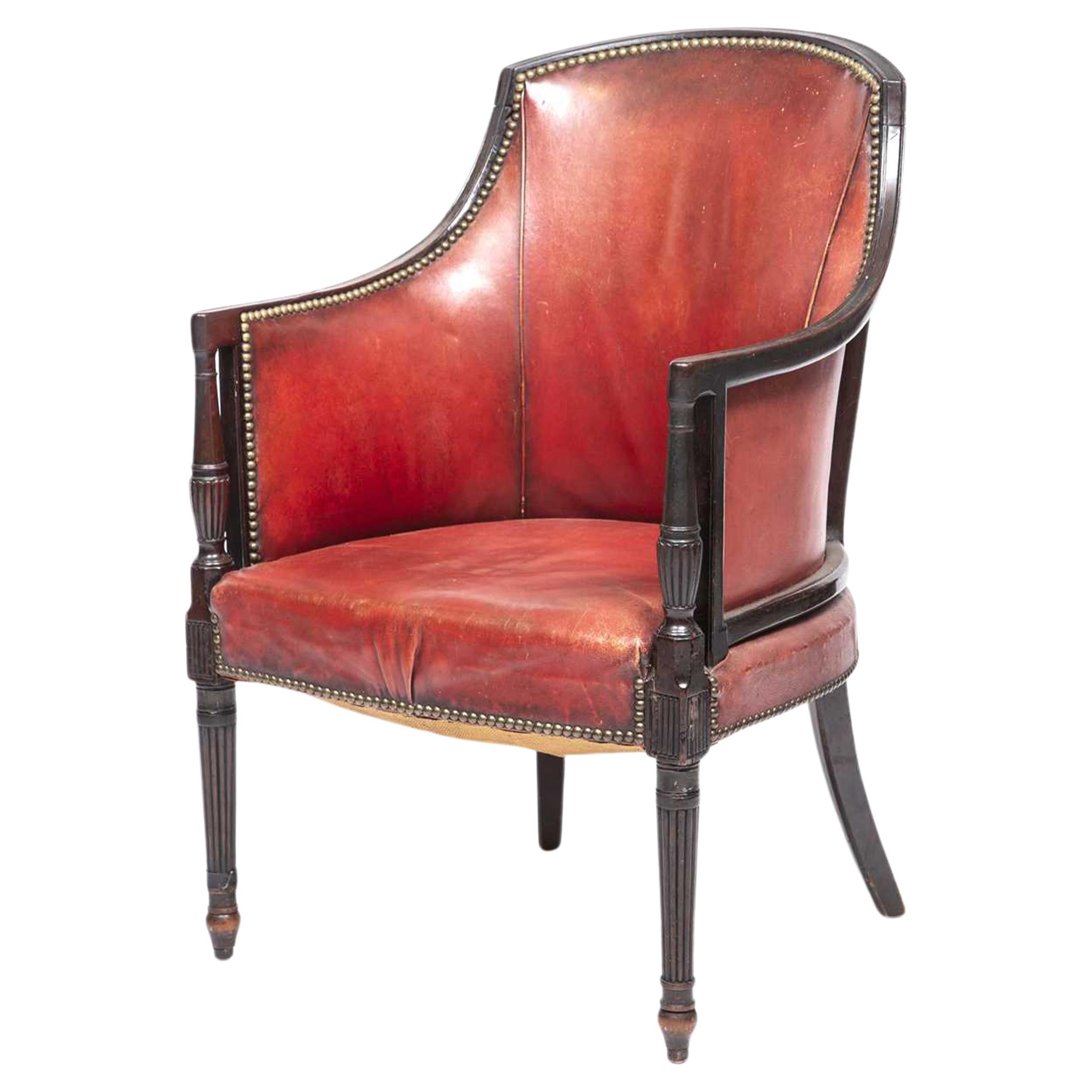 19th century Red Leather Library Tub Chair With Brass Stud Detailing & Reeded Front Legs from the The Oxford Library, Oxford, England. 

Other dimensions 

Height to arms 66cm
Height to seat 41

Depth of seat 49cm
Width of seat at widest