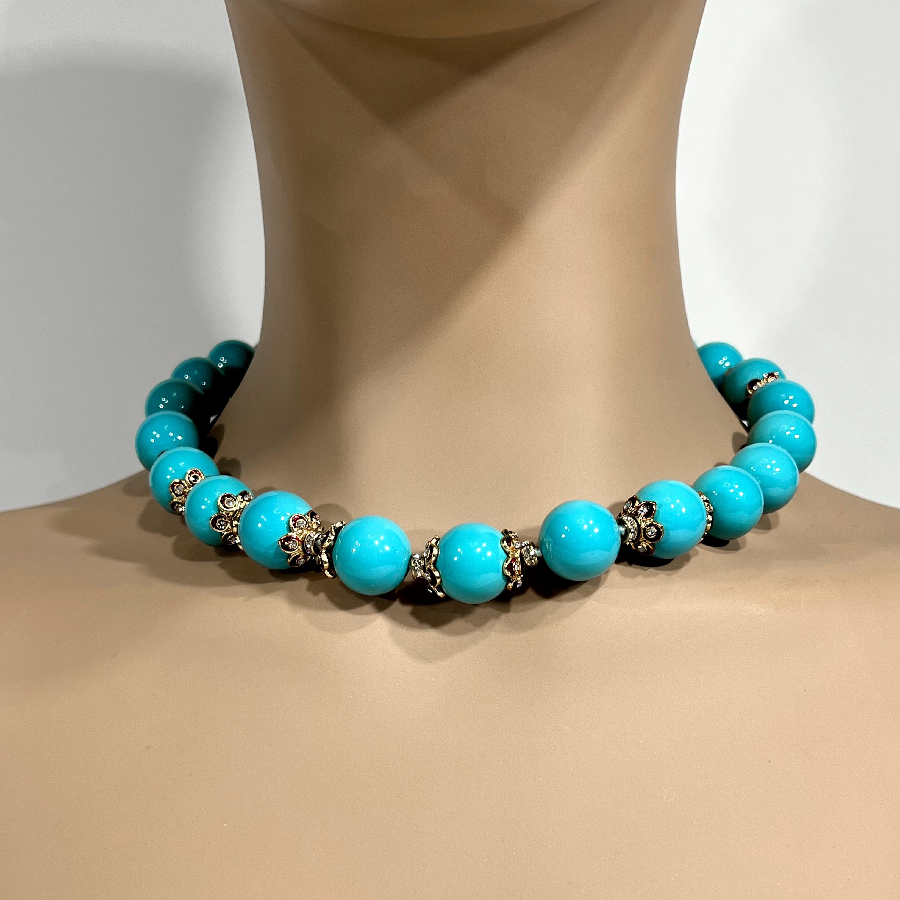 
Our Palm Beach Look collection features an elegant strand of man-made 16mm turquoise beads interspersed with gilt and diamante enamel set rondels made to an 18-inch length silk strung attached to an easy gilt clasp.  Perfect for layering with