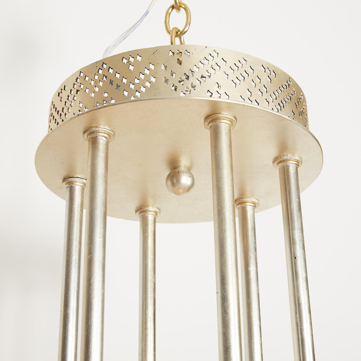 Inspired by Egyptian prayer shawls, the Palmyra ceiling fixture emits light through stylized Deco patterns rendered in brass with an engraving technique. The patterns are an homage to the Tulle-bi-telli textile of the Asyut province of Egypt, a
