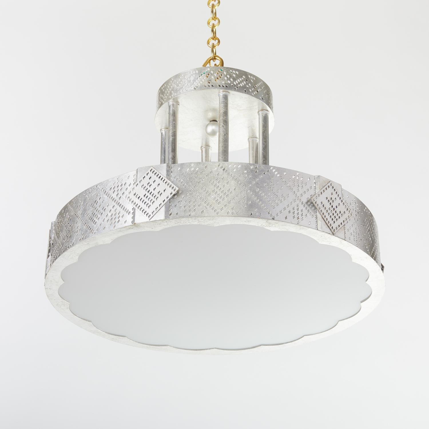 Inspired by Egyptian prayer shawls, the Palmyra I ceiling fixture emits light through stylized Deco patterns rendered in brass with an etching technique with an aluminum leaf finish. The patterns are an homage to the Tulle-bi-telli textile of the