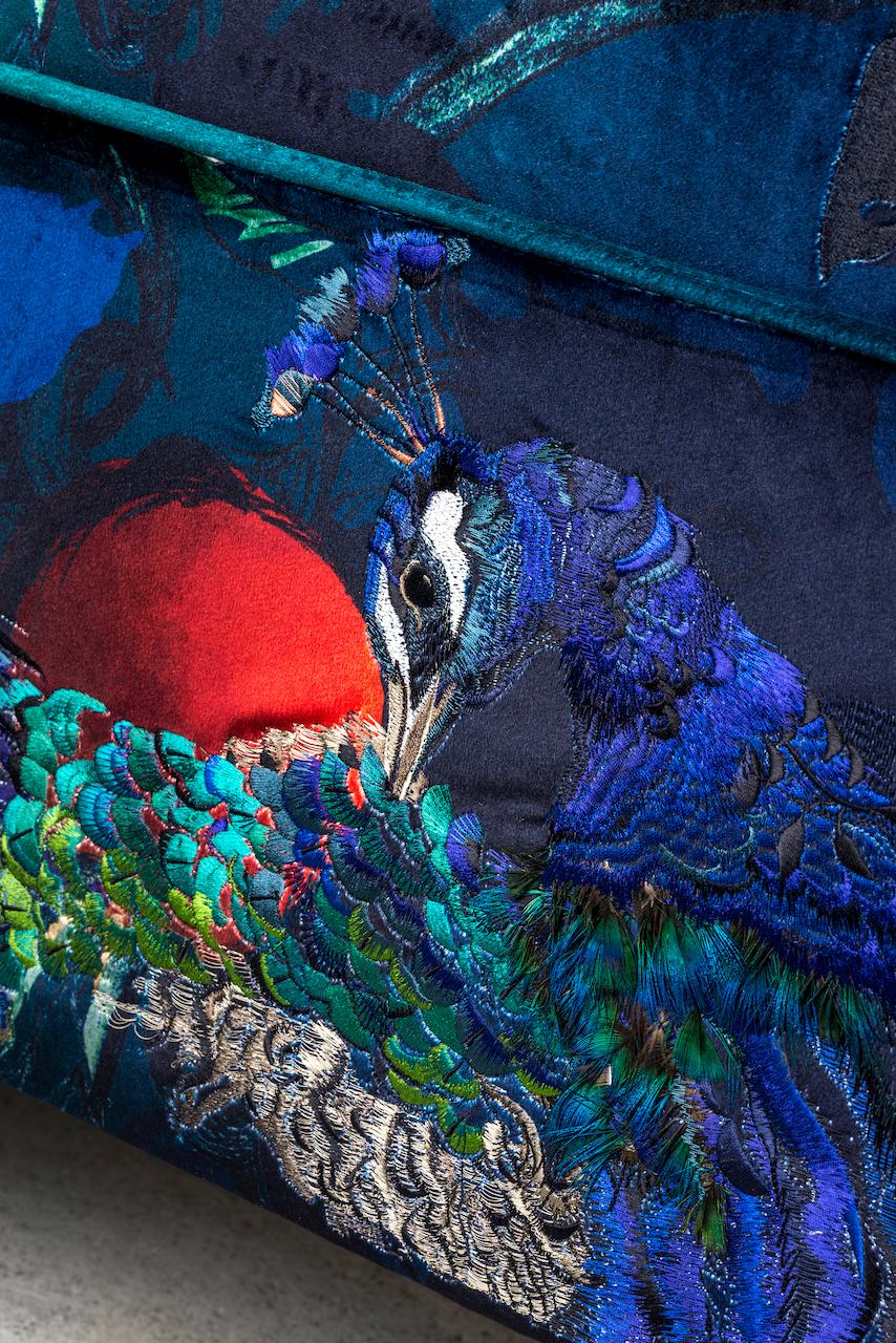 The 'Peacock and Squirrel Ottoman' by award-winning, British embroidery artist and designer, Jacky Puzey. This piece is lavishly upholstered with embroidered velvet and appliqué work of silk organza, faux fur and peacock feathers. It is constructed