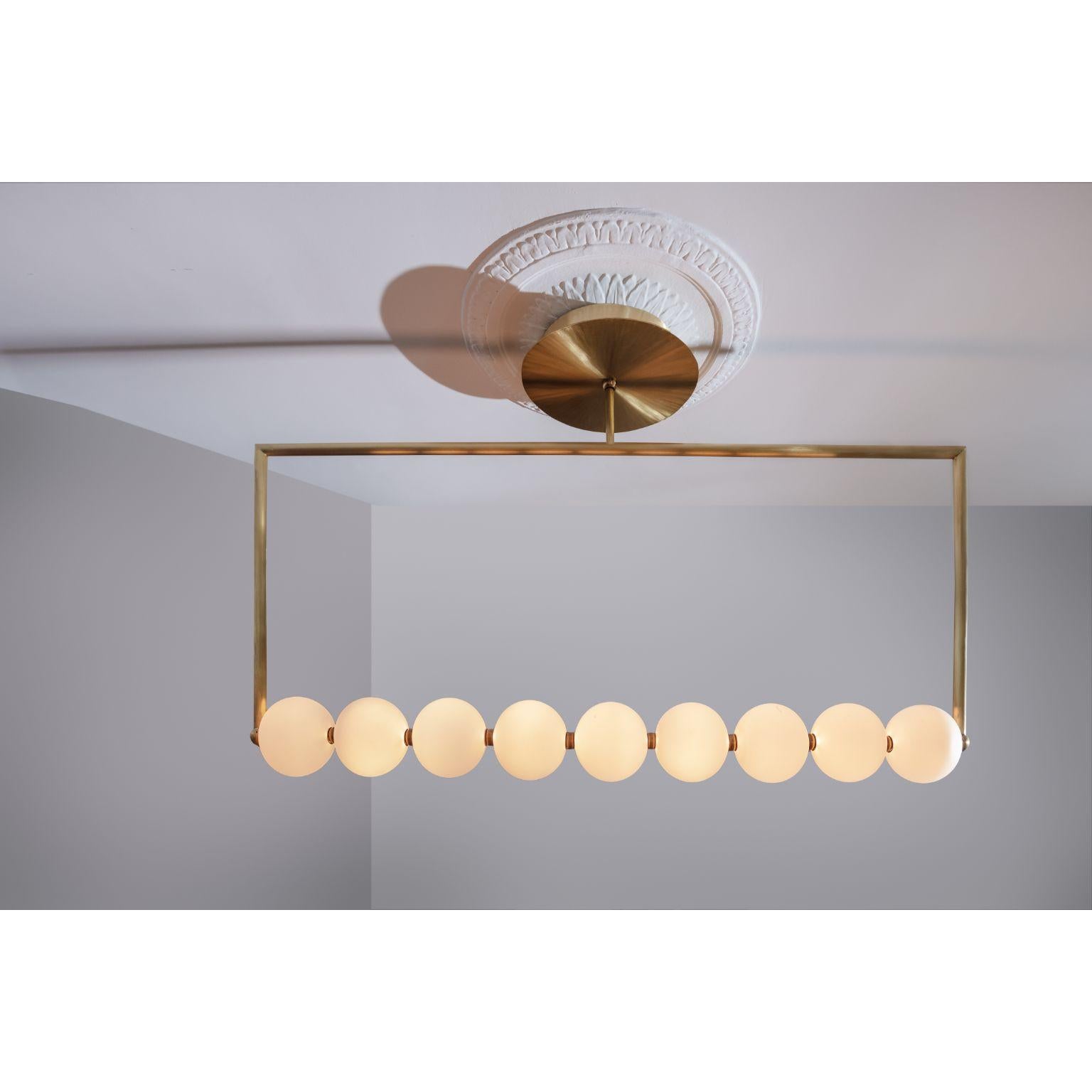 The Pearl Line by Ludovic Clément d'Armont
Materials: Blown glass, brass joints, LEDs
Dimensions: D 12 x W 122 x H 67 cm

The Pearl line is a simple architectural element that helps structure a space. 
Depending on the shape you choose, it is