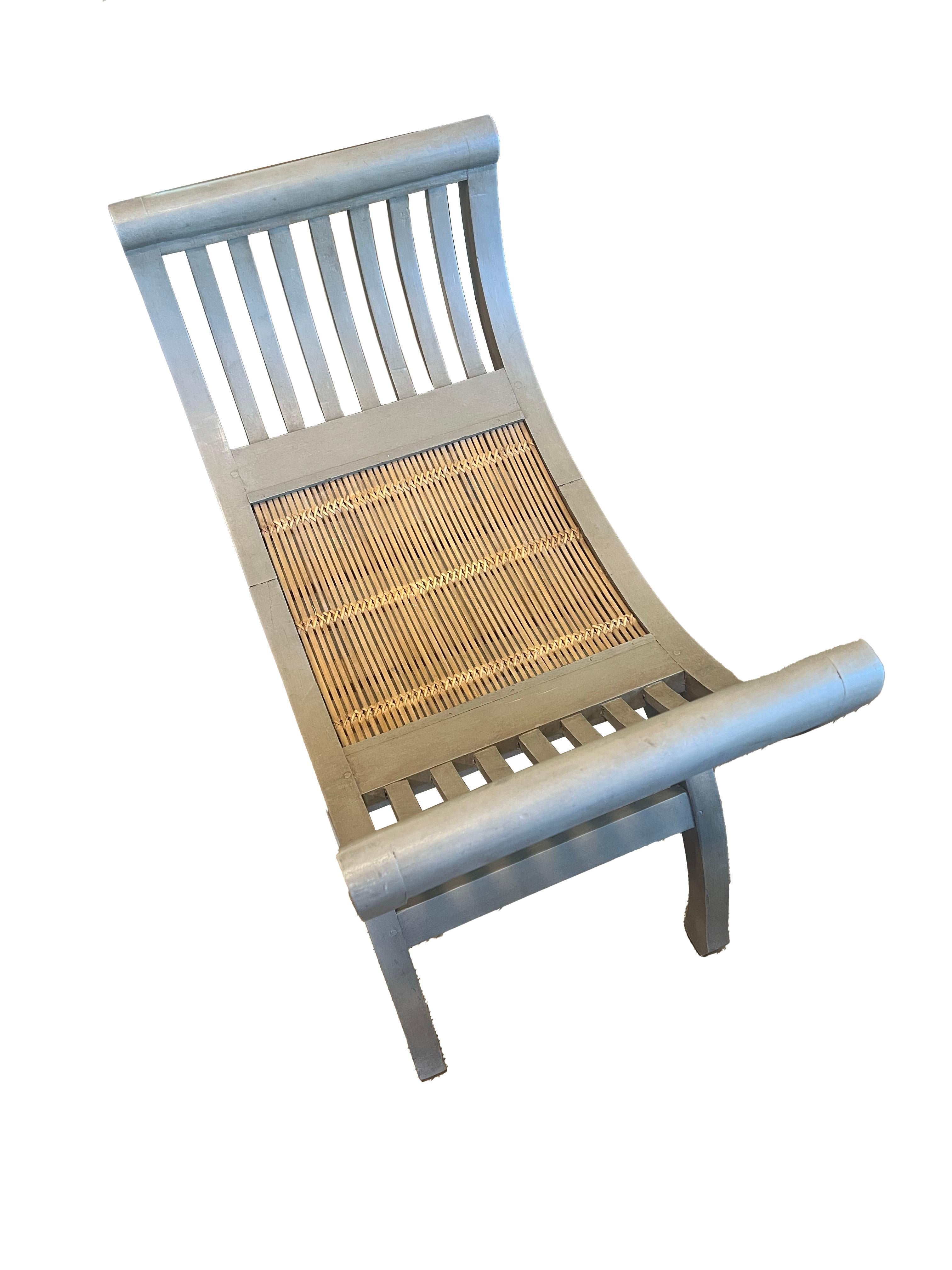 A stunning bench featuring a woven bamboo seat and a custom finish, exemplifying the perfect blend of artistry and functionality. The curved shape and silhouette of this bench add an exquisite touch to any space, enhancing its visual appeal and