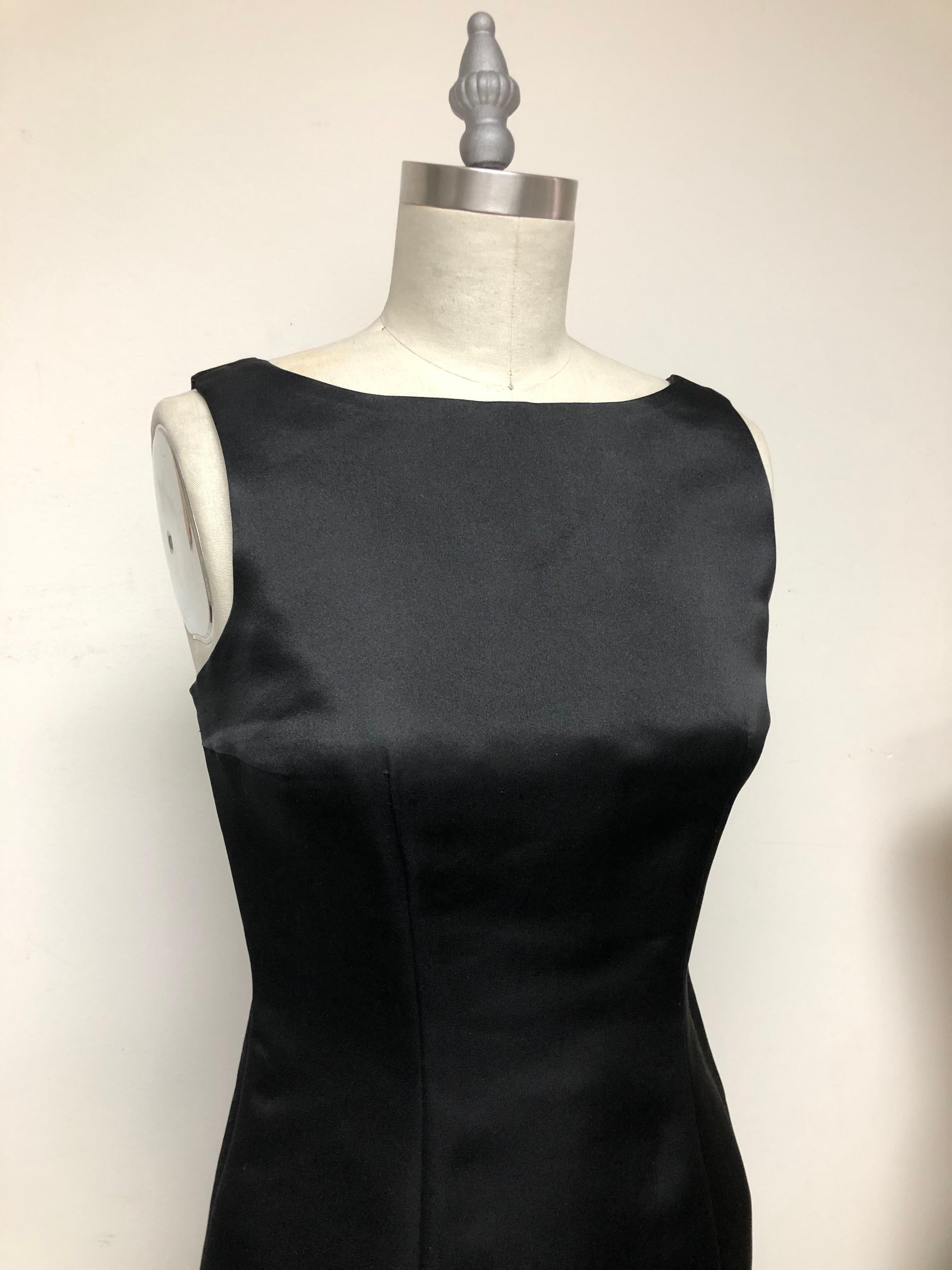 The perfect Little Black Dress in the Finest Italian Satin. Bateau Neckline with Back Straps and slit. The chicest and most wearable year round. Add your bijou, Manolo's and Long Gloves ....Audrey would approve. This dress is timeless and never
ends