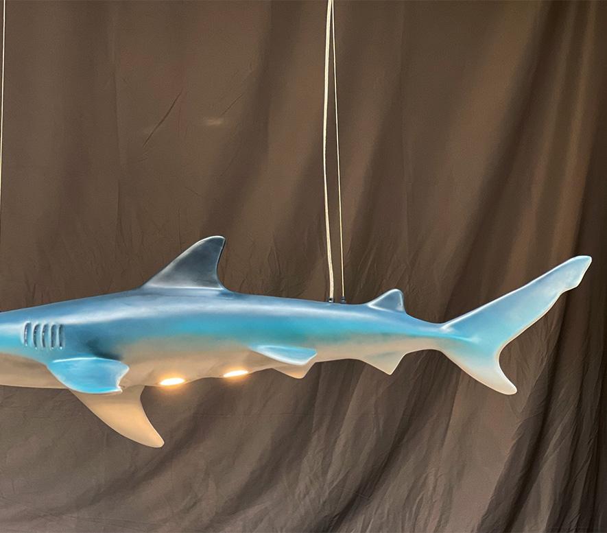 Dun-da.
Dunda.
Dun-da, dunda-da.
Dunda, DUNDA,DUNDA!DUNDA!!! ( Jaws sound track.)

Who doesn't a four foot shark hanging over their pool table? This, to be named by you, life like shark comes wIth three adjustable, LED, spot lights in his belly