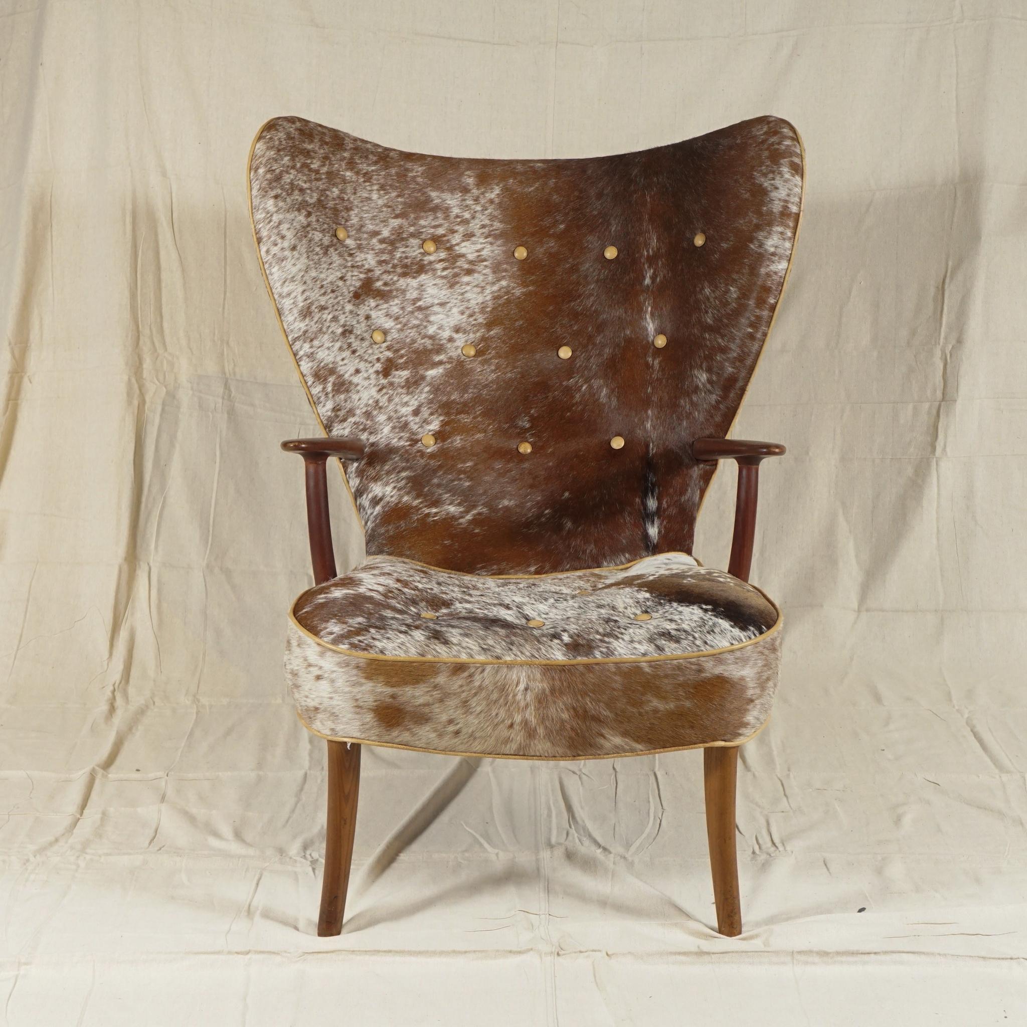 The Pragh chair, a distinctive wingback chair, by Madsen & Schubell, a Danish firm established in 1944 in Copenhagen. Newly recovered in a handsomely patterned soft cowhide, this iconic chair designed by Madsen & Schubell from 1950s is a standout.