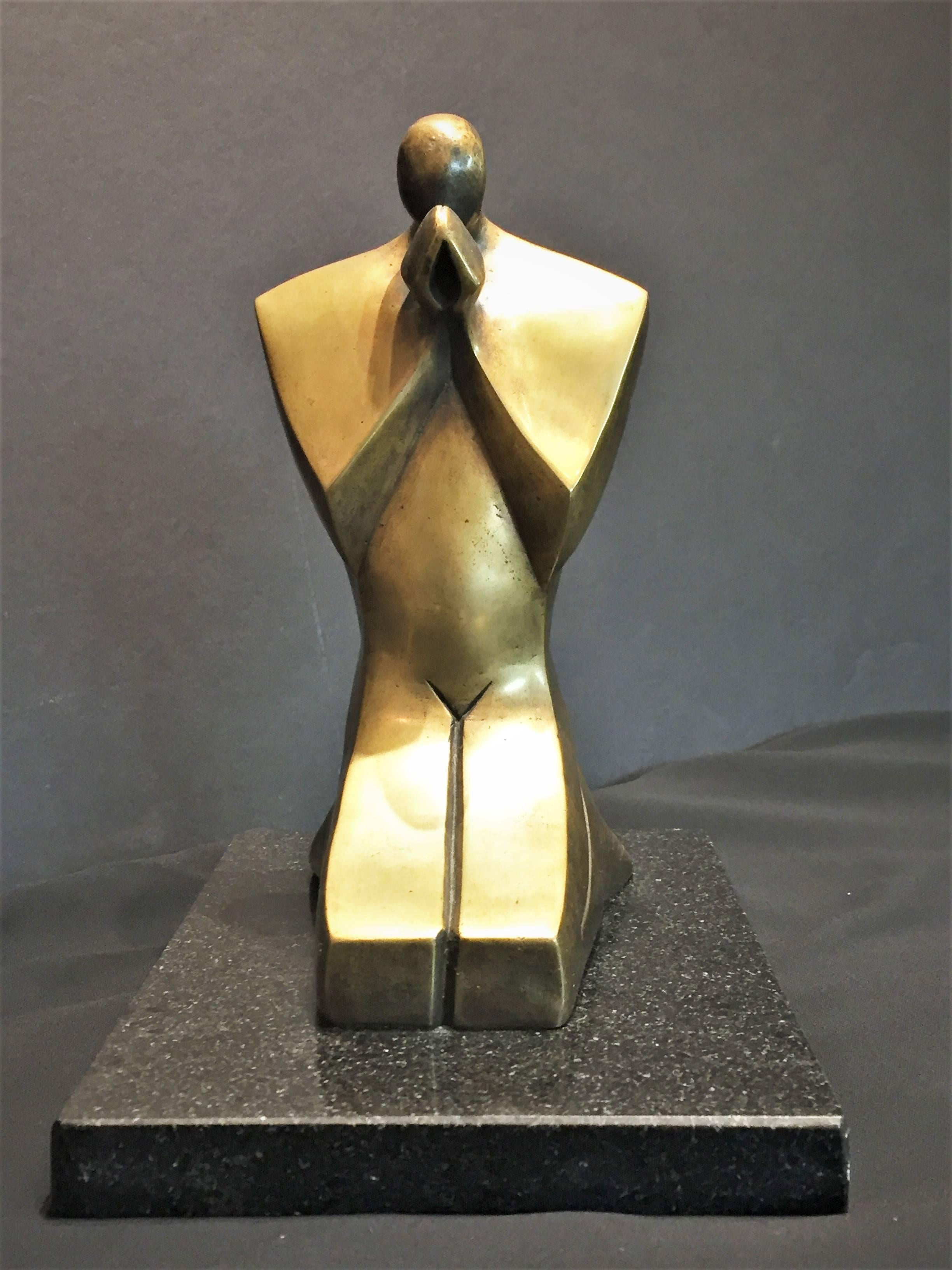 An unusual streamlined modern depiction of a praying man in polished bronze. Original marble base. Very heavy. Unsigned.