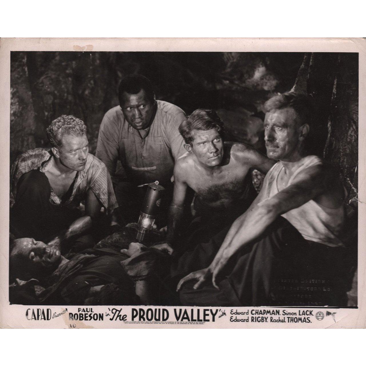 Original 1940 British silver gelatin single-weight photo for the film The Proud Valley directed by Pen Tennyson with Paul Robeson / Edward Chapman / Simon Lack / Rachel Thomas. Very good-fine condition. Please note: the size is stated in inches and