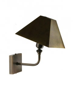 The Pyramid wall sconce made of cast and hand cut Brass shade in Bronze finish