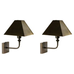 The Pyramid wall sconce made of cast and hand cut Brass shade in Bronze finish