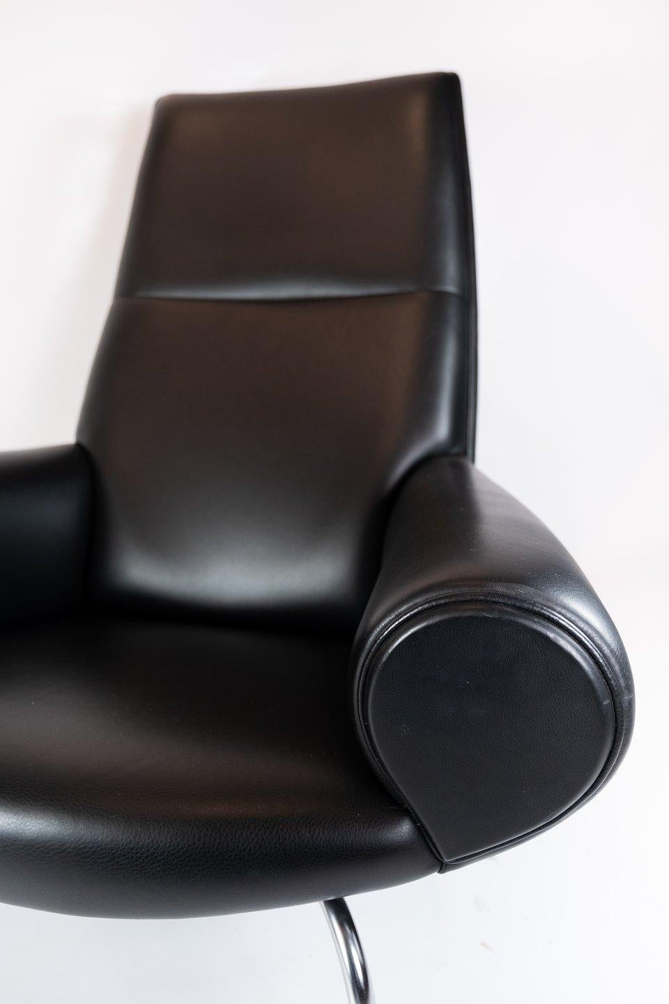 The queen chair, model EJ 101, designed by Hans J. Wegner and manufactured by Erik Jørgensen. The chair is upholstered with black leather and in great used condition.
  