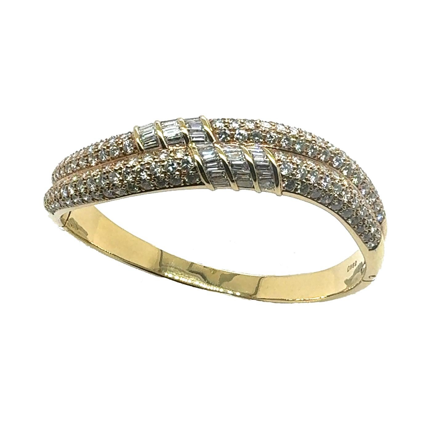 Gemstone
Diamond:  8.62Ct.
Metal: 18K Yellow Gold

           The Radiant Elegance Diamond Bangle is a masterpiece of jewelry design. It features two rows of pavé-set round brilliant diamonds, creating a continuous sparkle that captures the light
