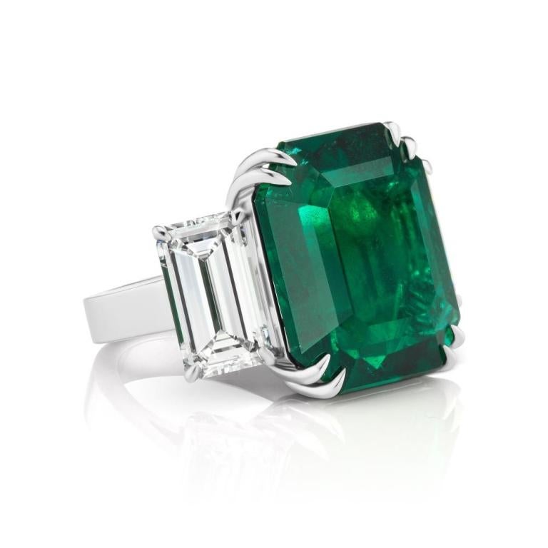 THE RARE AND UNIQUE NO OIL ZAMBIAN EMERALD AND DIAMOND RING A simply stunning and substantial (Gubelin, GIA,GRS and C.Dunaigre Certified) NO OIL treated Zambian Emerald is the star of this classic ring set in platinum. The 24.18 ct. vibrant green