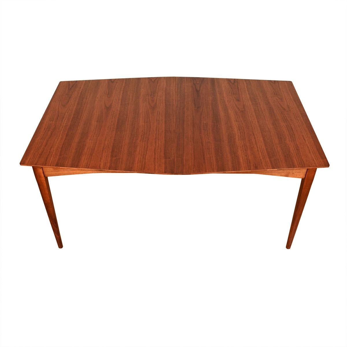 Gorgeous mid-century table with an unusual shape! Nice mid-Size for daily use and expands to a long length by the insertion of up to two leaves.
Great old American craftsmanship and quality materials ensure this will last another 60 years with