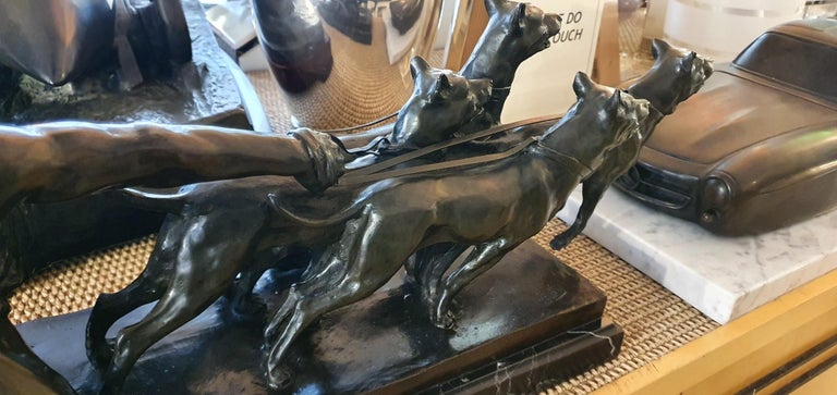 A striking Art Deco bronze of four hounds straining at their leashes and being held back by their male keeper. The figures are set on a bronze sôcle and then mounted on a black marble plinth. 

Signed KELETY in the bronze. French, circa