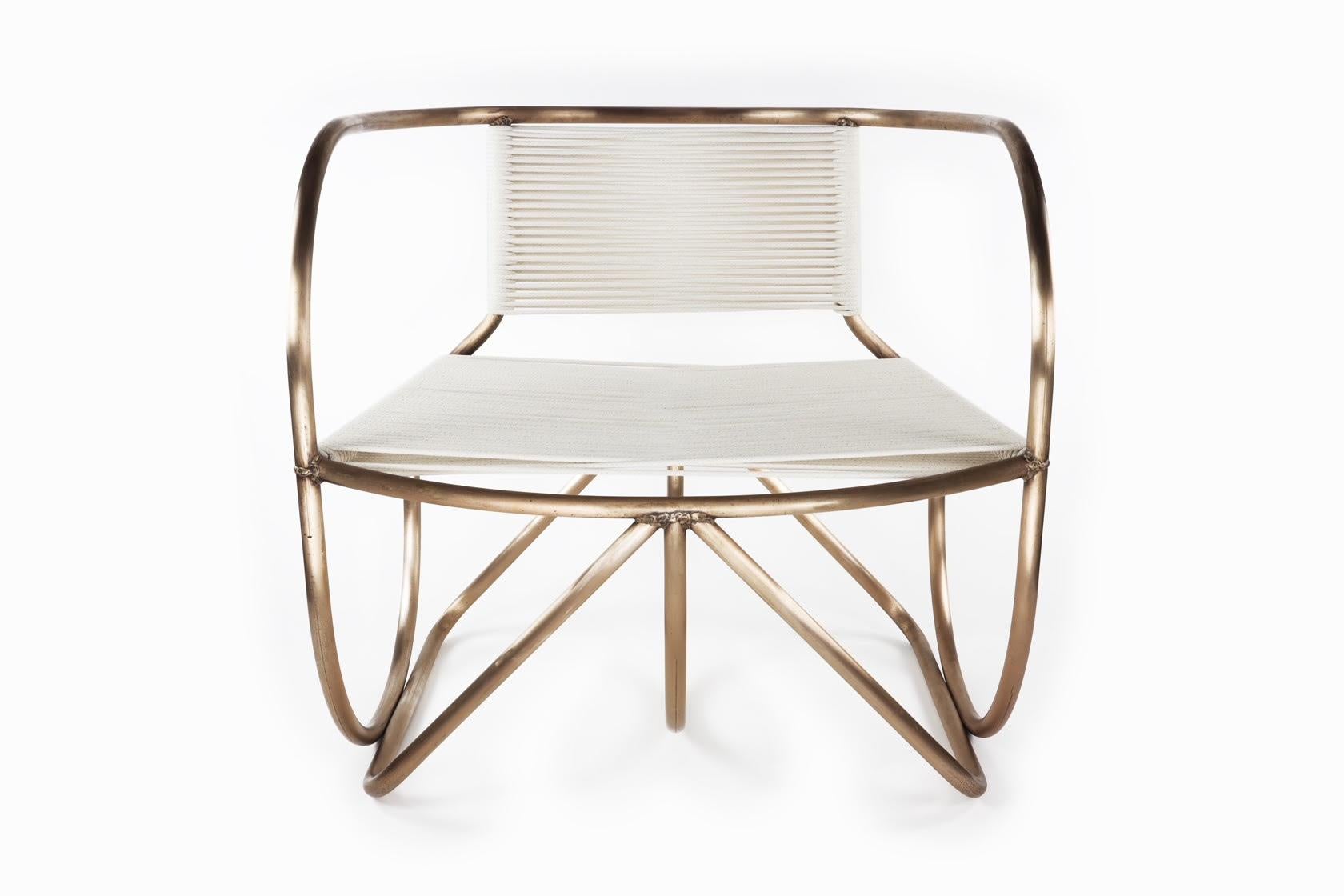 Bronze tube is masterfully bent to create the oversized frame of the Restraint Rocker Lounge Chair. The lines suggest that maybe it is a rocker, yet they are fluid curves that are stationary. The 1