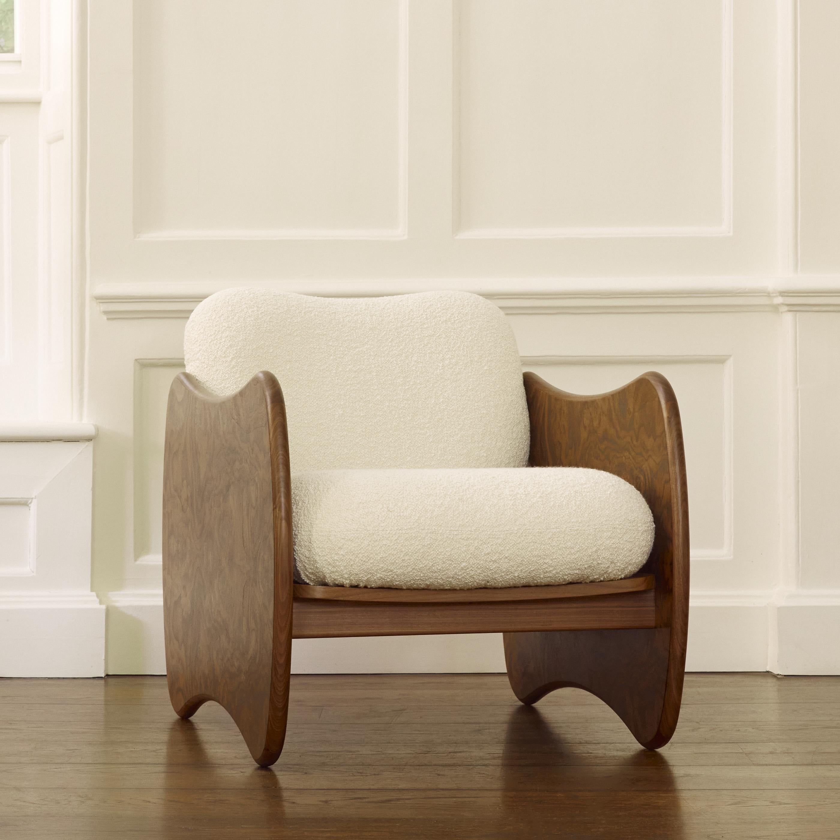 The swoop on our Rhino Chair arm rest is reminiscent of the elegant curve of its parent creature’s back. The frame is wrought from burl walnut veneer, with solid walnut rails for a minimalist and sleek rear. The thick seat pads offer plush comfort,