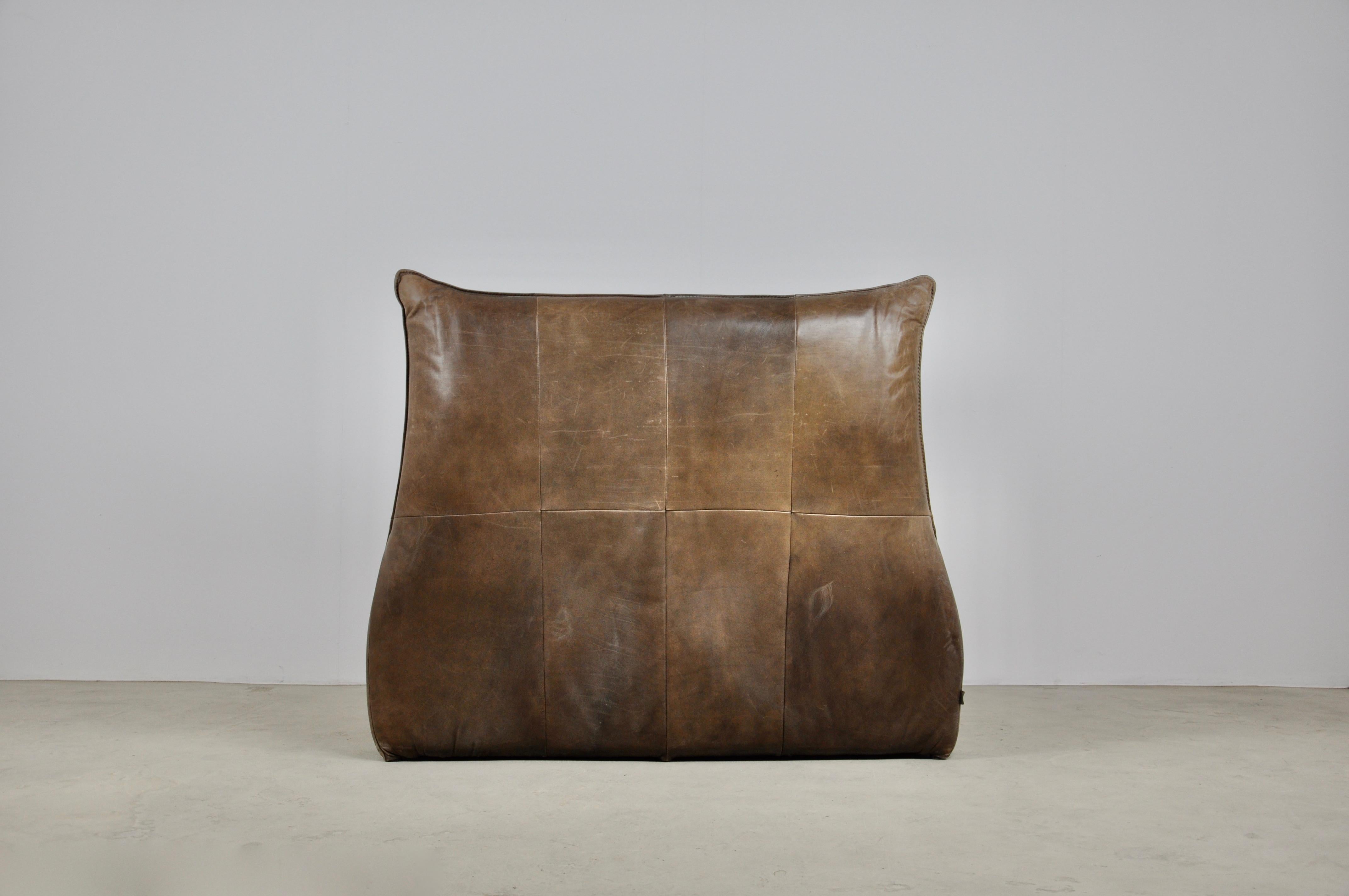 Leather armchair. Wear and tear due to time and the age of the armchair.
