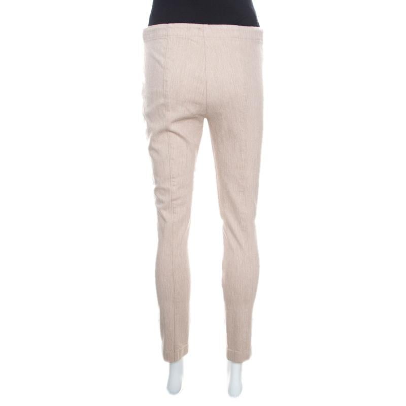 These fabulous denim pants from The Row are all you need to make an impressive style statement! The beige pants are made of a cotton blend and feature a slim fit silhouette. They come equipped with a zip closure and will look great with simple tops