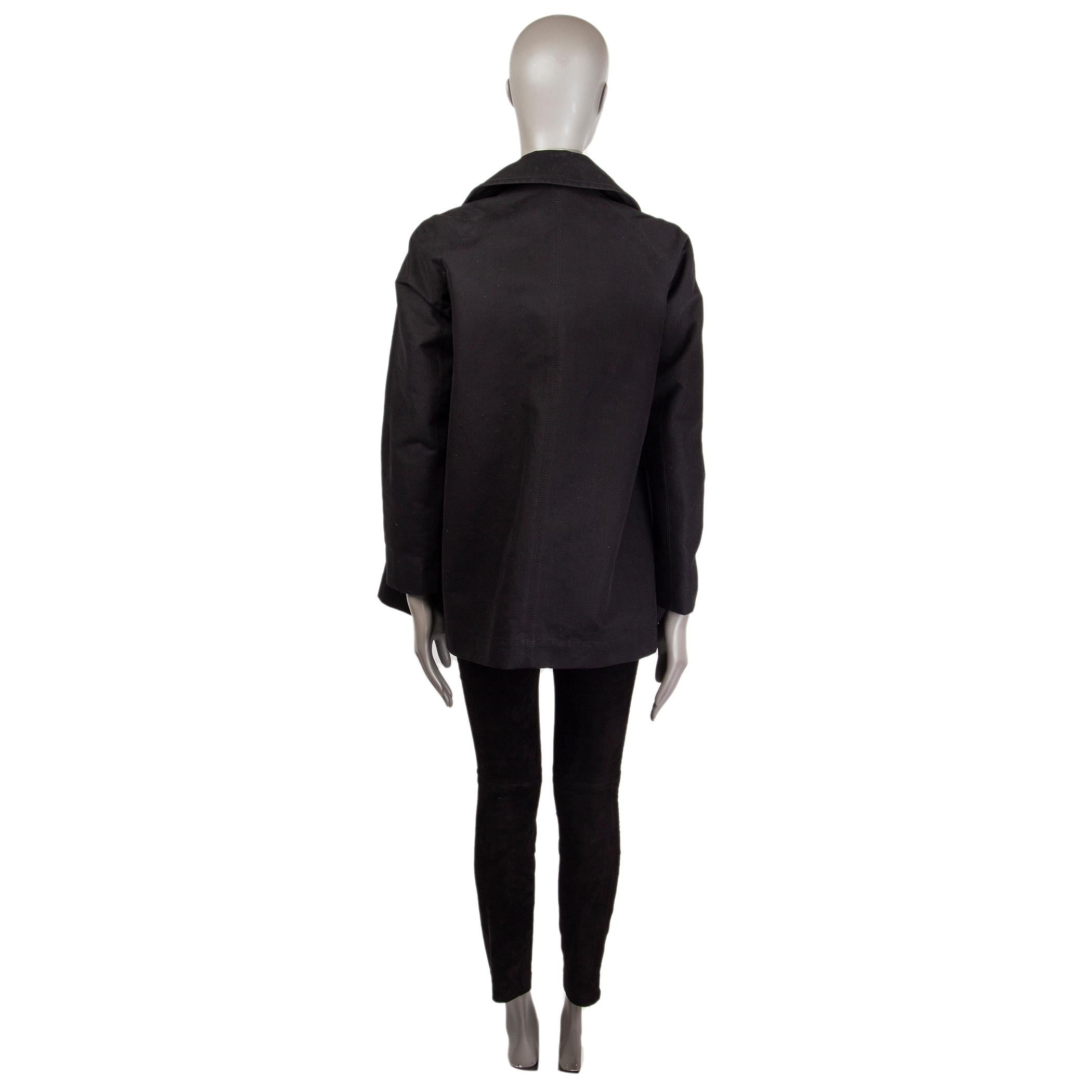 100% authentic The Rowdouble-breated gabardine coat in black cotton (100%). With noch collar and two pockets on the front. Closes with concealed buttons on the front. Partially lined in black cupro (100%). Has been worn and is in excellent