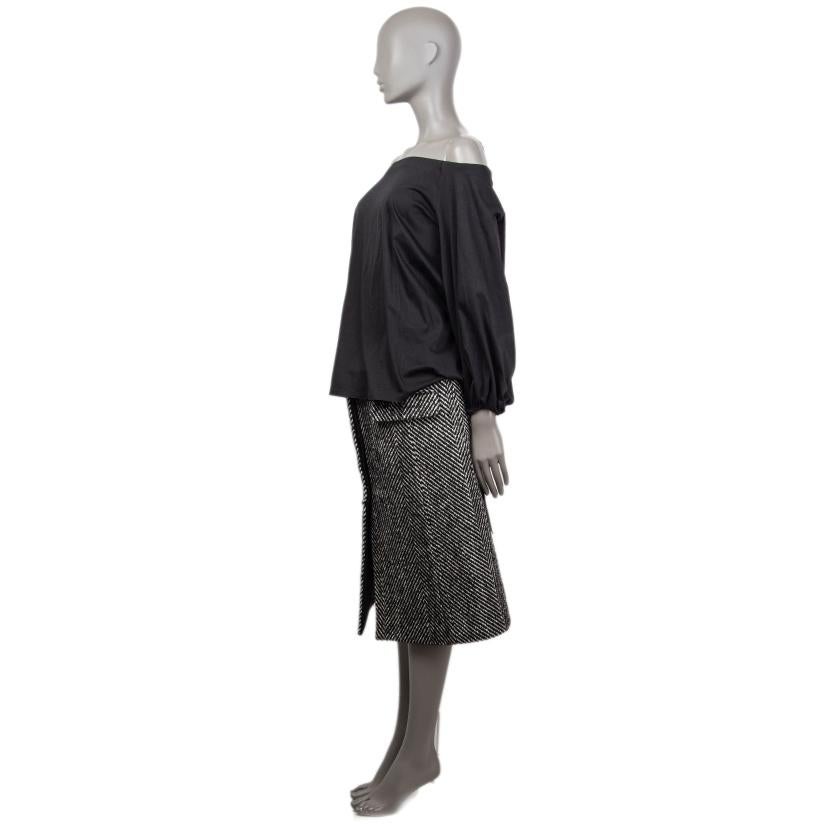 100% authentic The Row off-shoulder blouse in black cotton (100%) with an elastic band at the shoulders and cinched cuffs. Unlined. Has been worn and is in excellent condition.

Measurements
Tag Size	S
Size	S
Shoulder Width	39cm (15.2in)
Bust	110cm