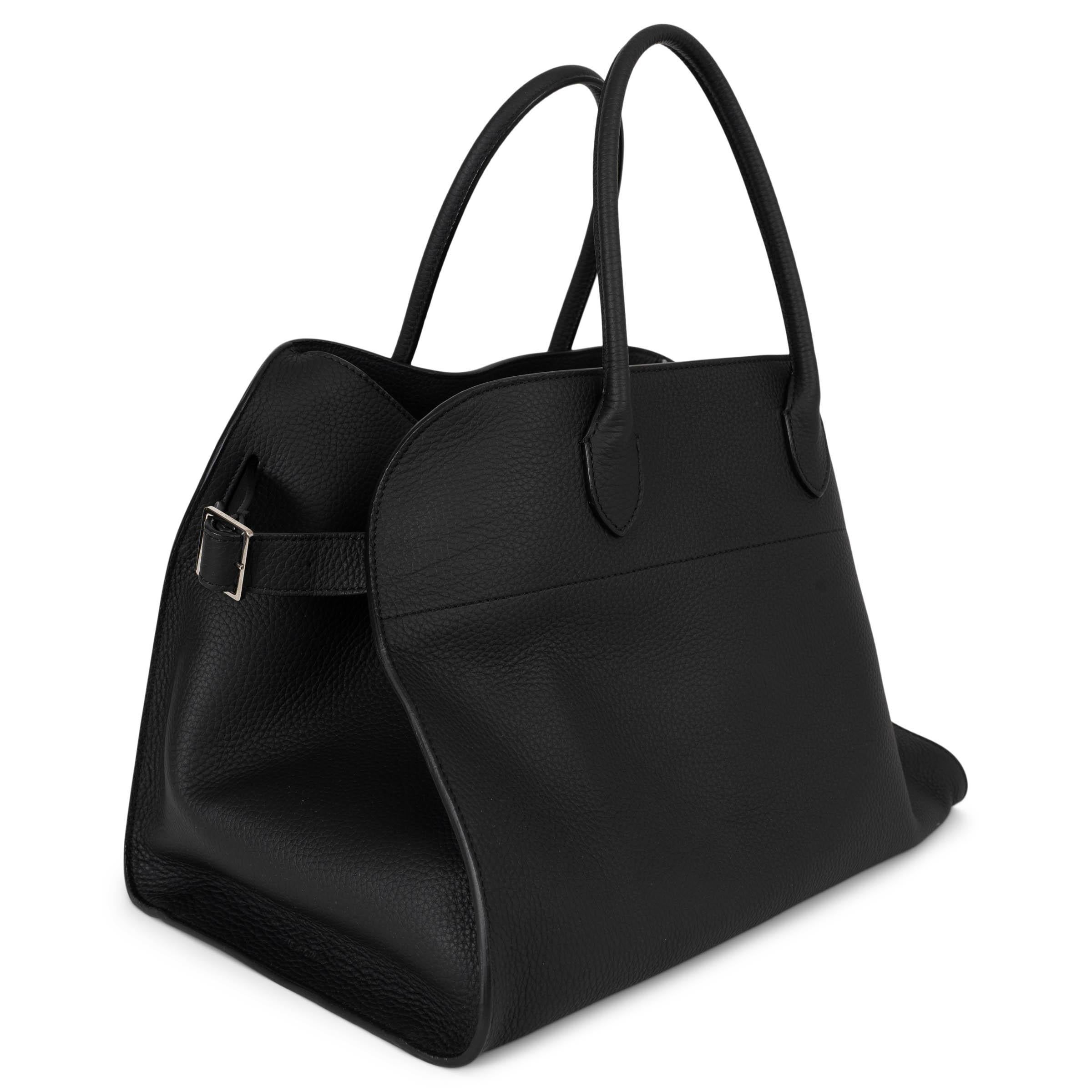 This 100% authentic The Row Soft Margaux 15 tote bag in matte black grained leather is a refined balance of structure and softness. Featuring adjustable belts on the gussets, it allows for a customizable shape while maintaining its effortlessly