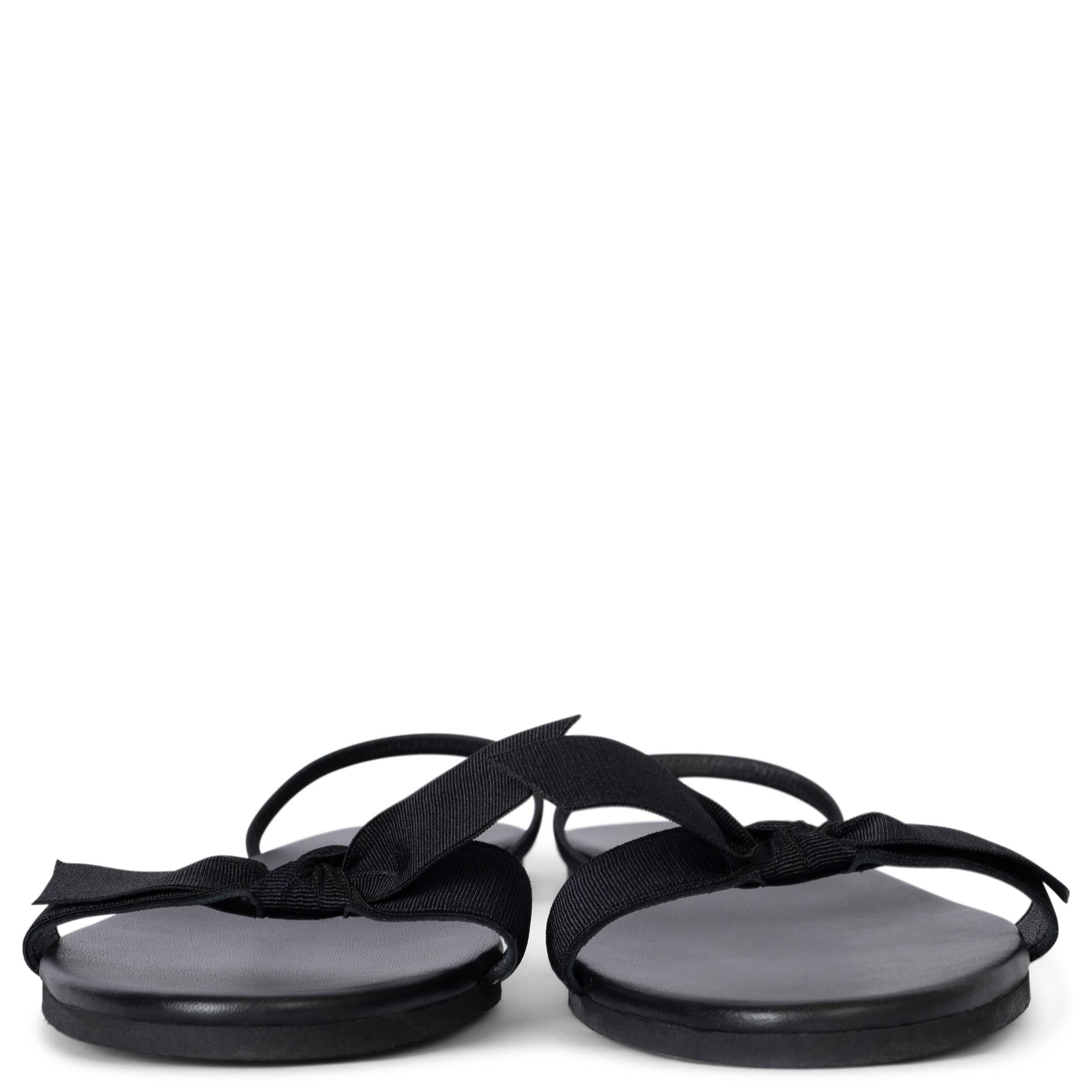 These 100% authentic The Row 'Bow' sandals are crafted from black supple leather, featuring a delicate grosgrain bow for a feminine touch. The design includes slim slingback straps that are elasticated for a comfortable fit, making these sandals
