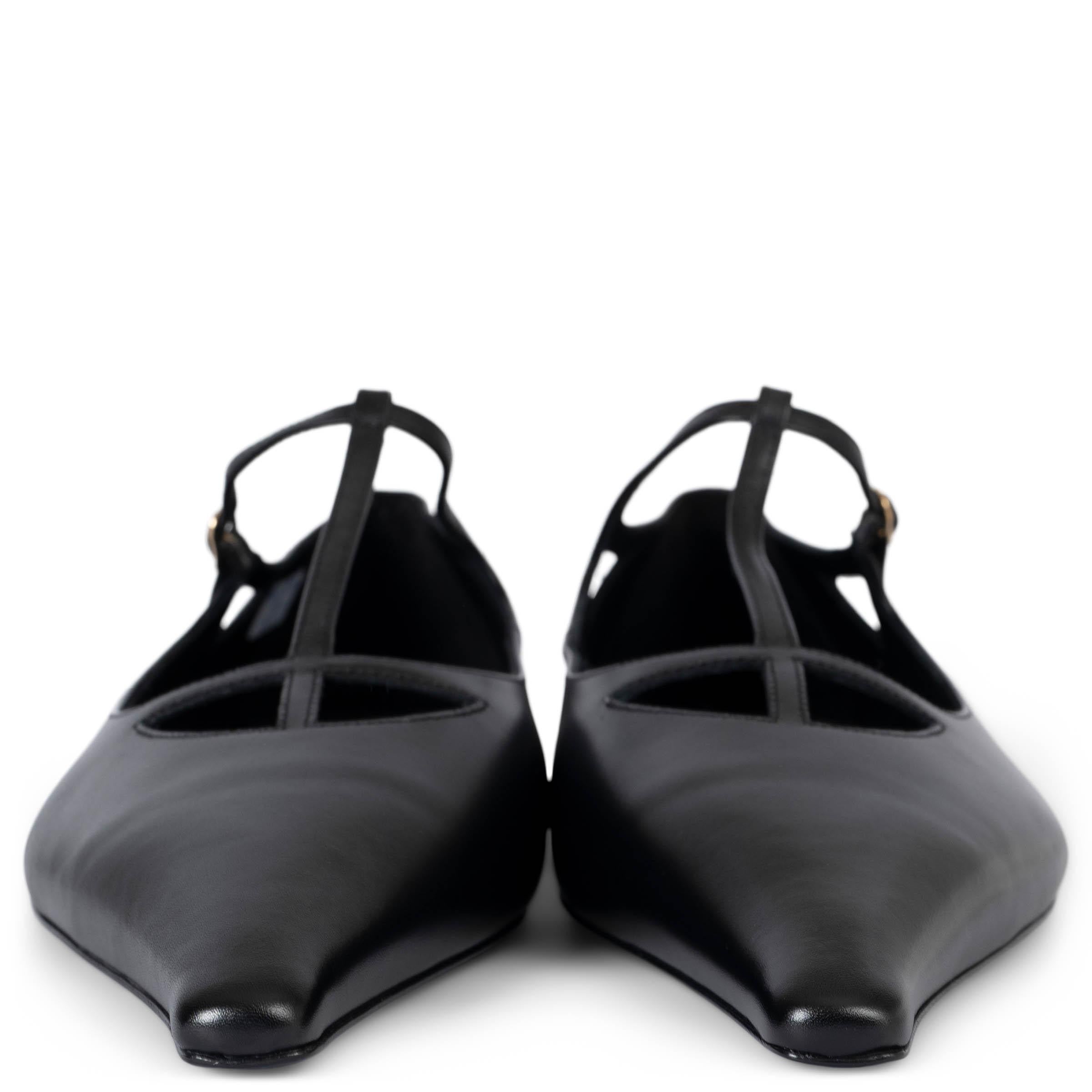 These 100% authentic The Row Cyd Mary Jane flats are crafted from black smooth leather and feature a sleek T-strap design with long pointed toes. They close with a silver-tone buckle and are finished with a delicate miniature heel, offering a