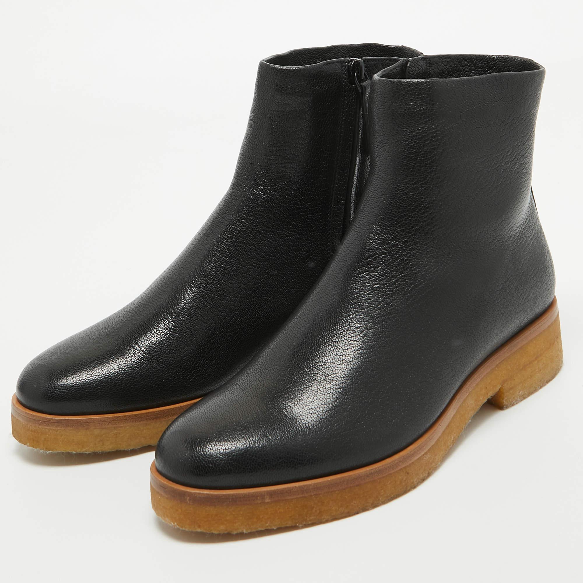 Step into sophistication with The Row's Boris ankle boots. Crafted with exquisite attention to detail, these boots exude timeless elegance. Luxurious black leather envelops the foot, while a sturdy sole provides both comfort and durability. Elevate