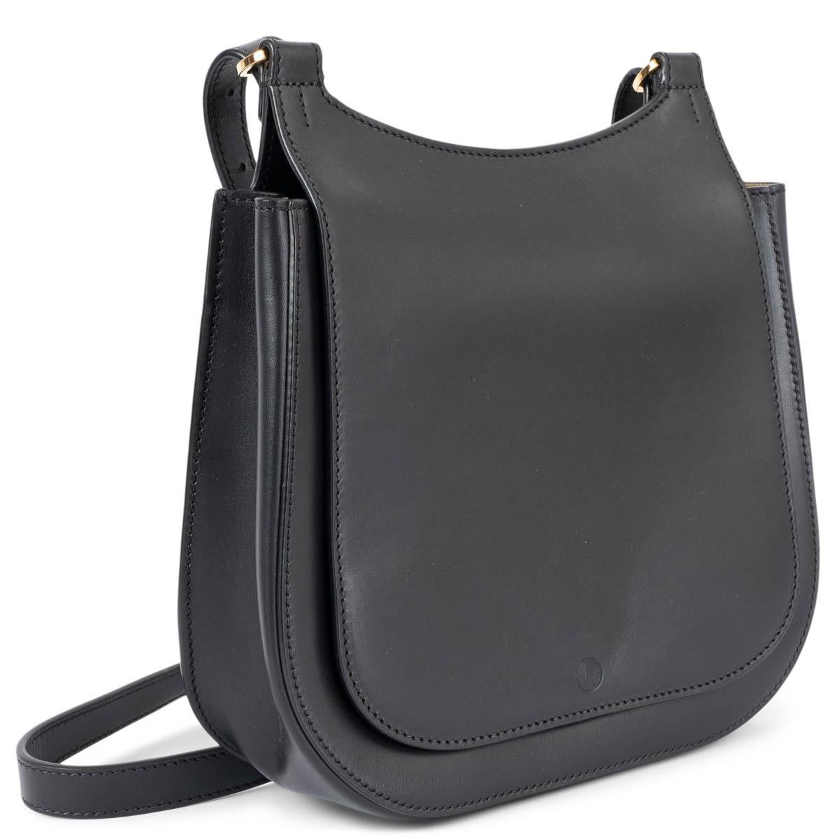 100% authentic The Row Hunting 7 crossbody bag in black smooth calfskin leather. Features an adjustable shoulder strap with gold-tone hardware and exterior pocket on the back. Closes with a concealed magnetic snap under the flap. Lined in beige