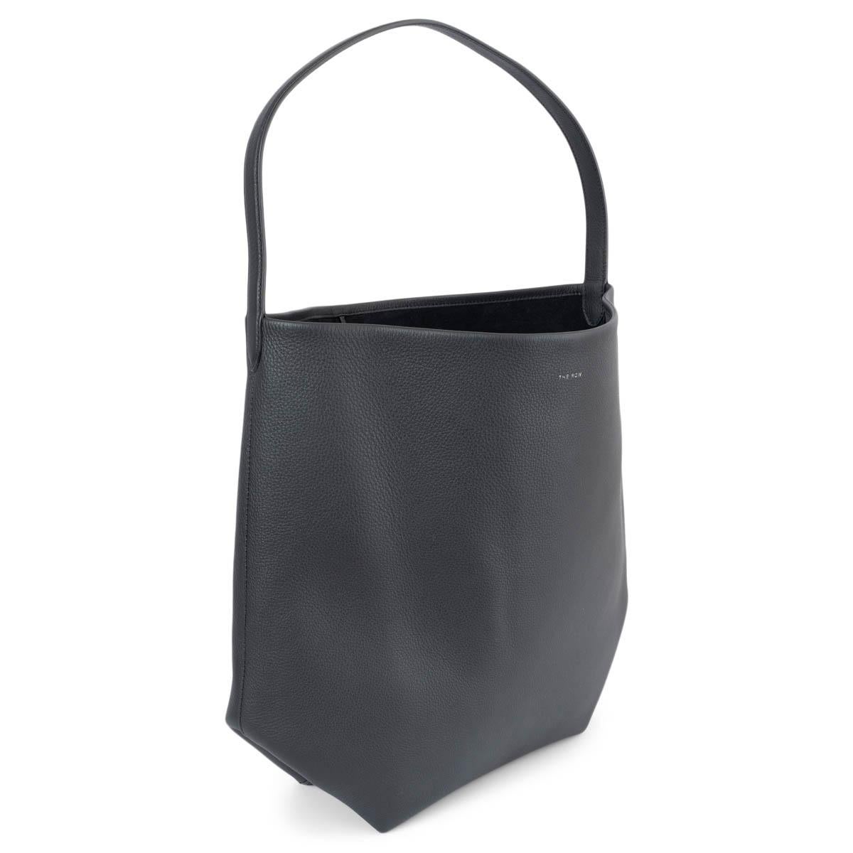 100% authentic The Row N/S Park Tote Hobo bag in pebbled black leather. Lined in supple suede and finished with a single slender strap. Closes with a string on top. Has been carried once or twice and is in virtually new condition.