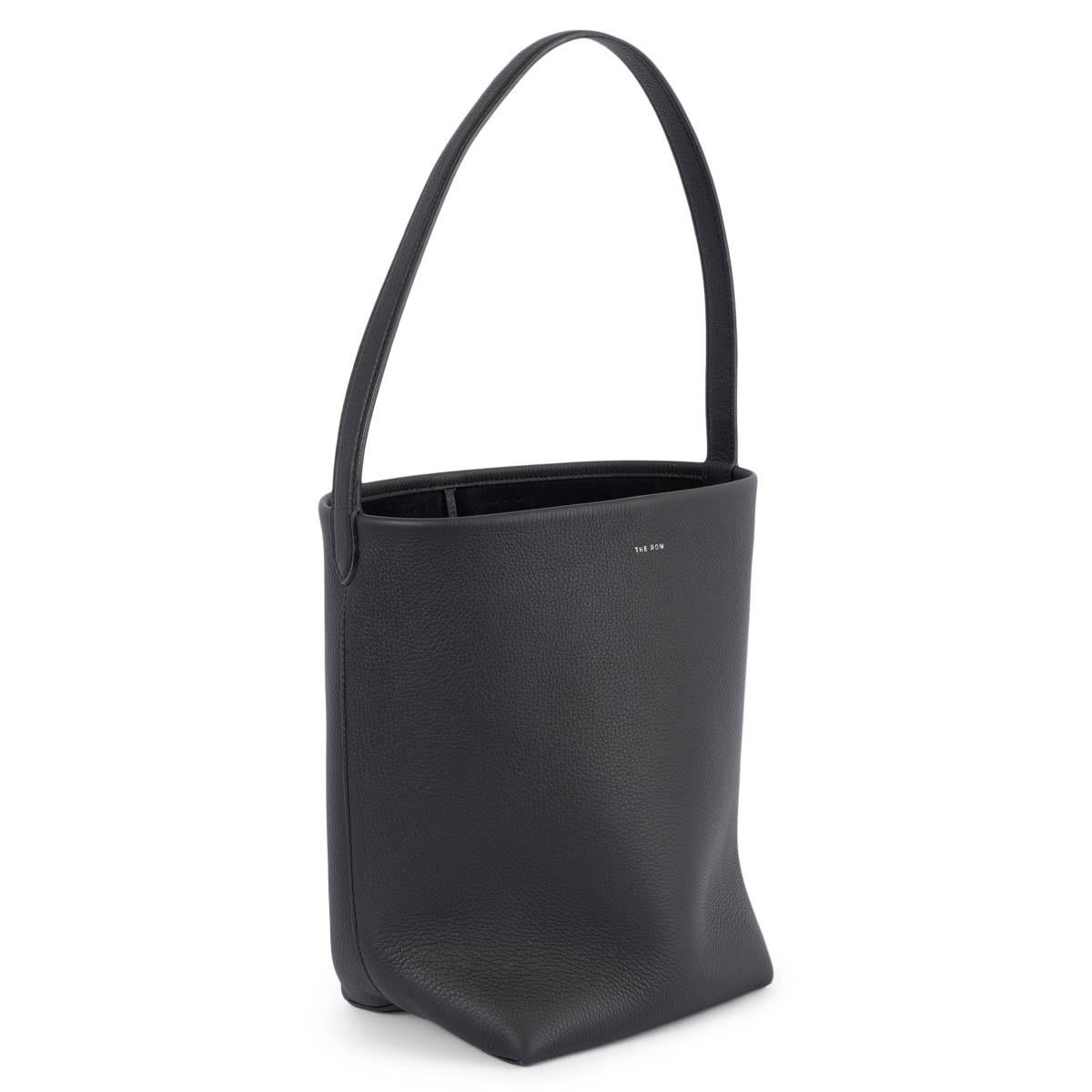 100% authentic The Row North South Park Medium tote bag in black pebbled calfskin. The design features label branding at front, a slim top handle, unlined with an open top.  Has been carried once and is in virtually new condition.