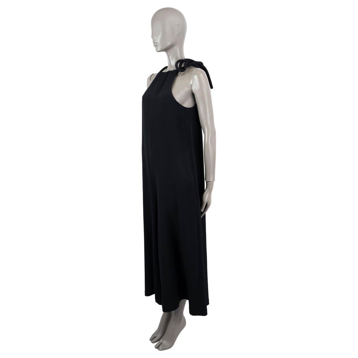 100% authentic The Row Japron sleeveless jumpsuit in black viscose (50%), acetate (47%) and elastane (3%). Lined in black silk (100%). The design features thick rope-style self-fastening neck ties, two slit pockets on the side and falls into cropped