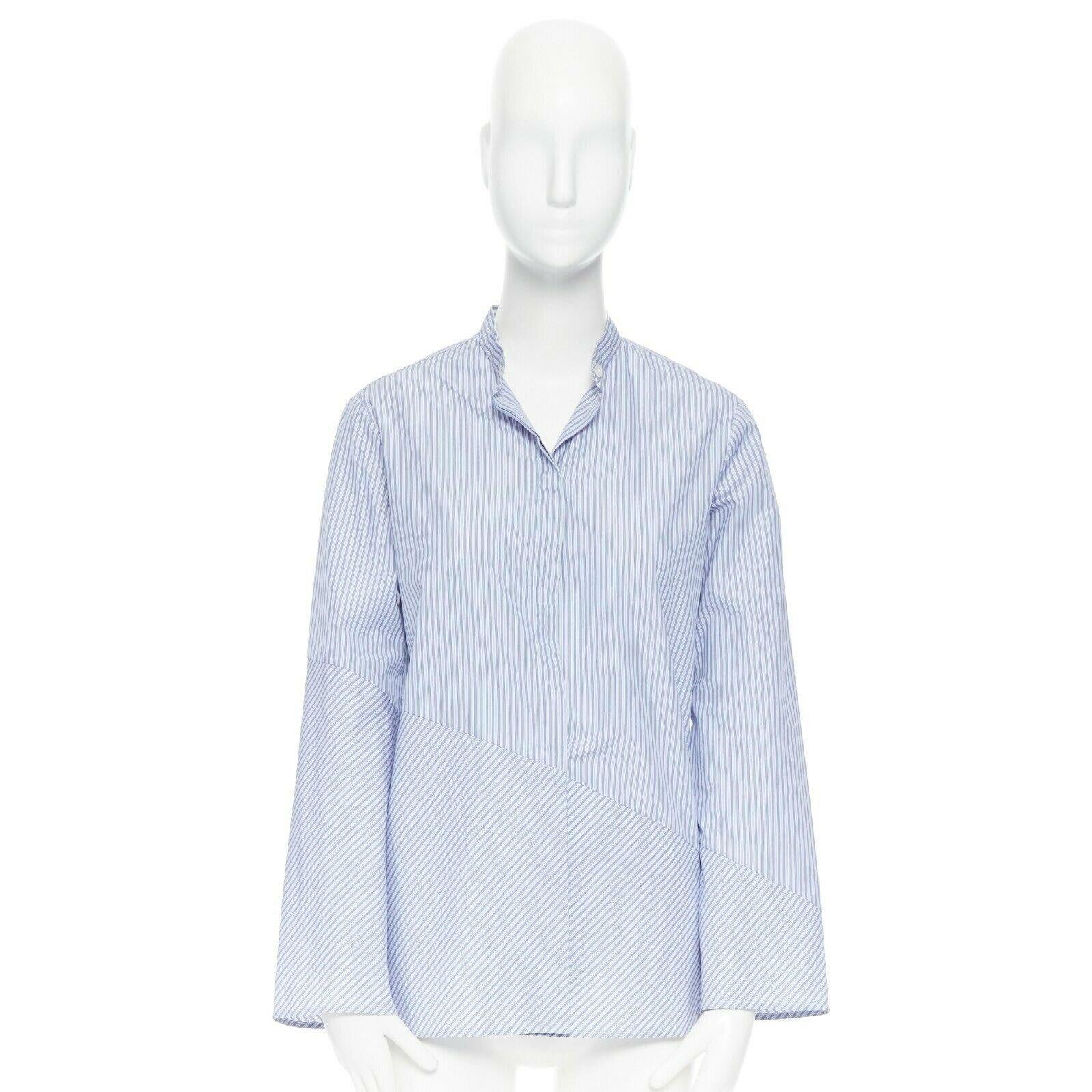 THE ROW blue 100% cotton pinstripe band collar asymmetric button-up shirt US2 
Reference: LNKO/A01160 
Brand: The Row 
Designer: Mary Kate and Ashley Olsen 
Material: Cotton 
Color: Blue 
Pattern: Striped 
Closure: Button 
Extra Detail: Pinstriped